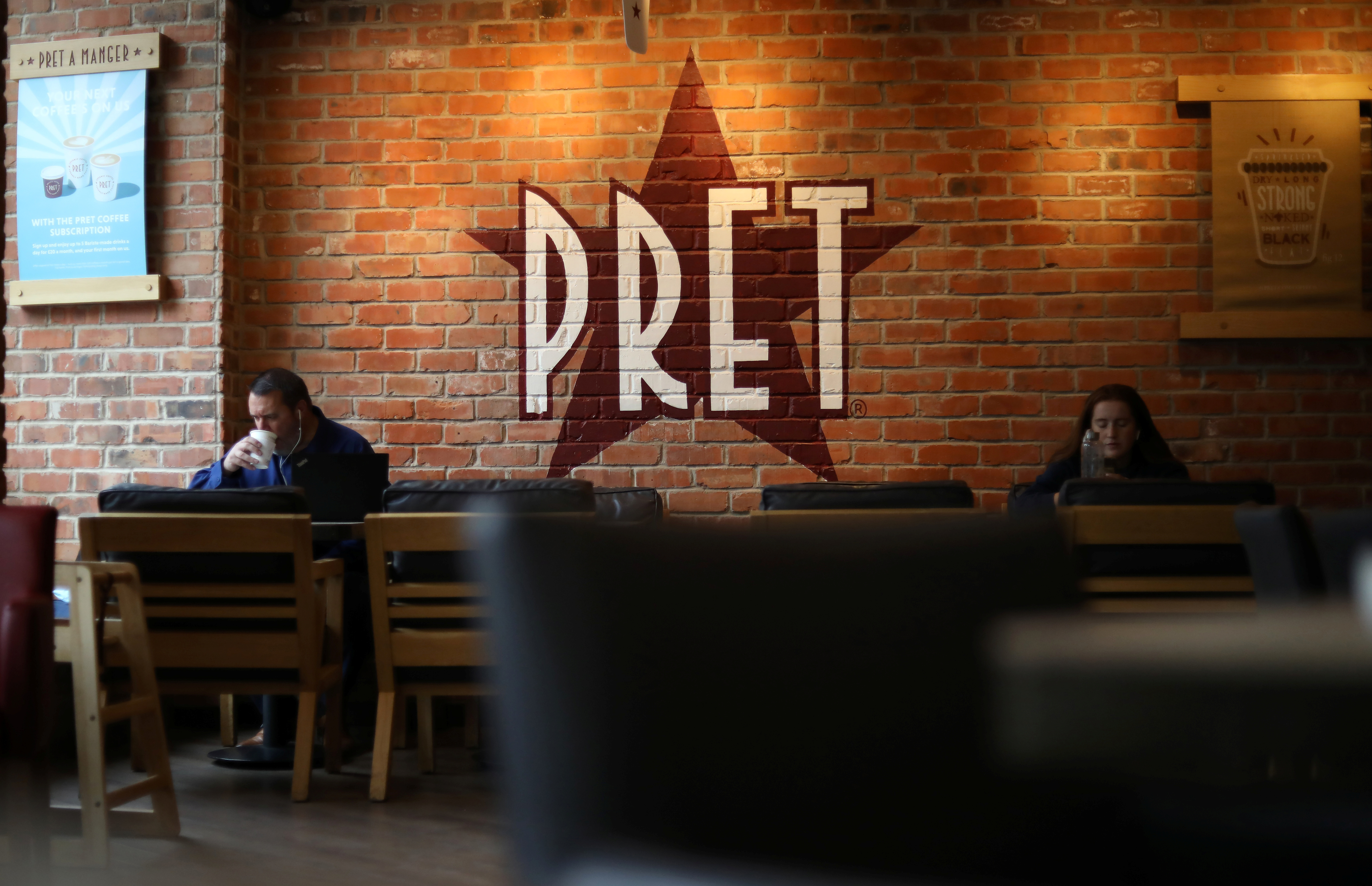 Customers sit inside a Pret A Manger store in Liverpool