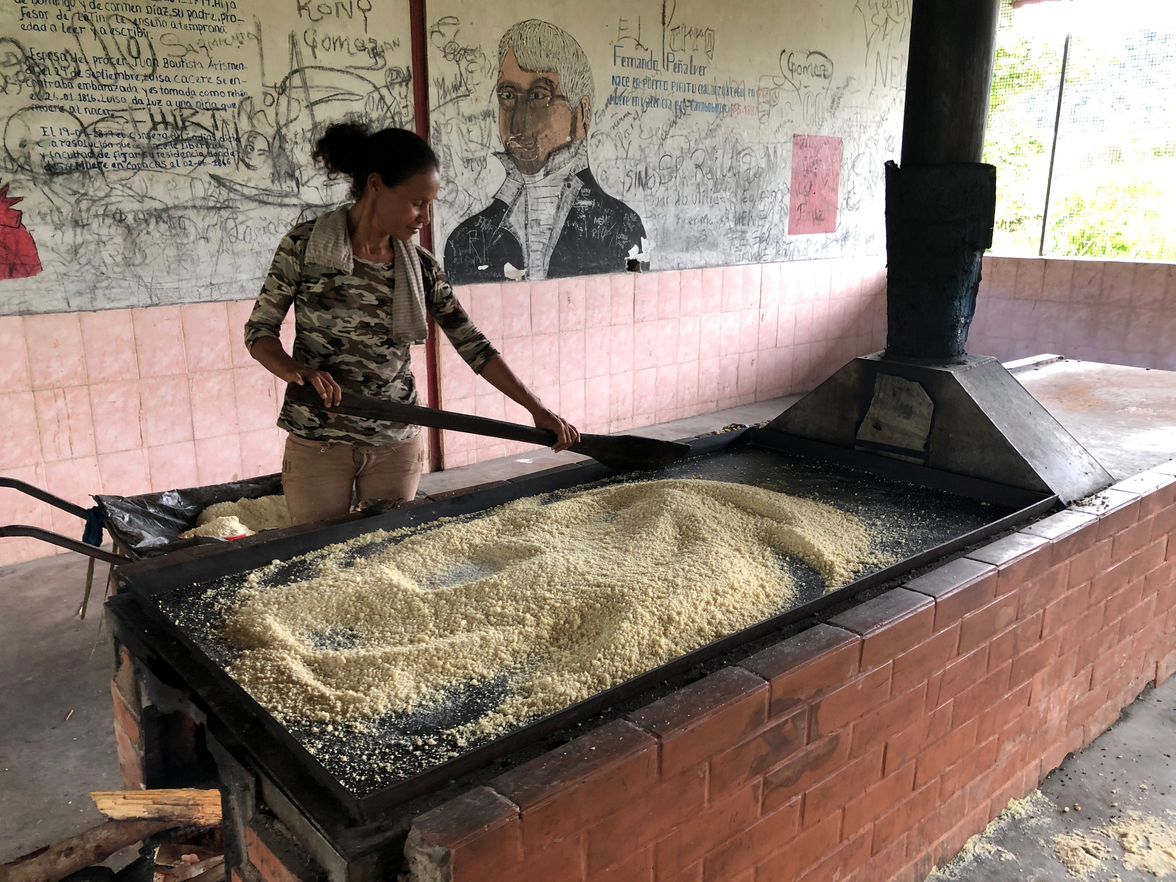 A resident prepares food in a village near the Colombian border