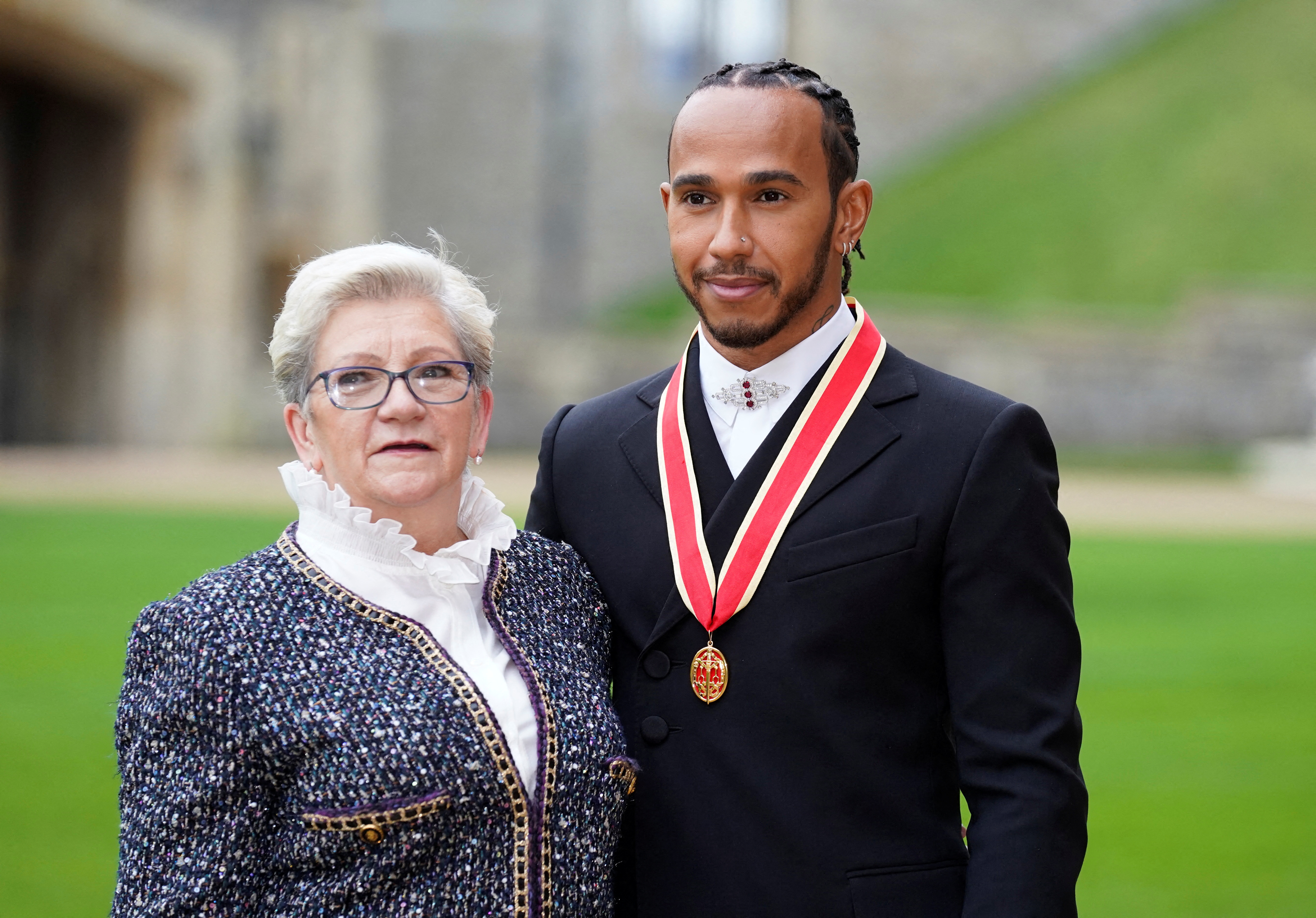 Lewis Hamilton poses with his mother Carmen Lockhart for a photo after he was made a Knight Bachelor by Britain's Charles, Prince of Wales, during an investiture ceremony at Windsor Castle in Windsor, Britain, December 15, 2021. Andrew Matthews/Pool via REUTERS