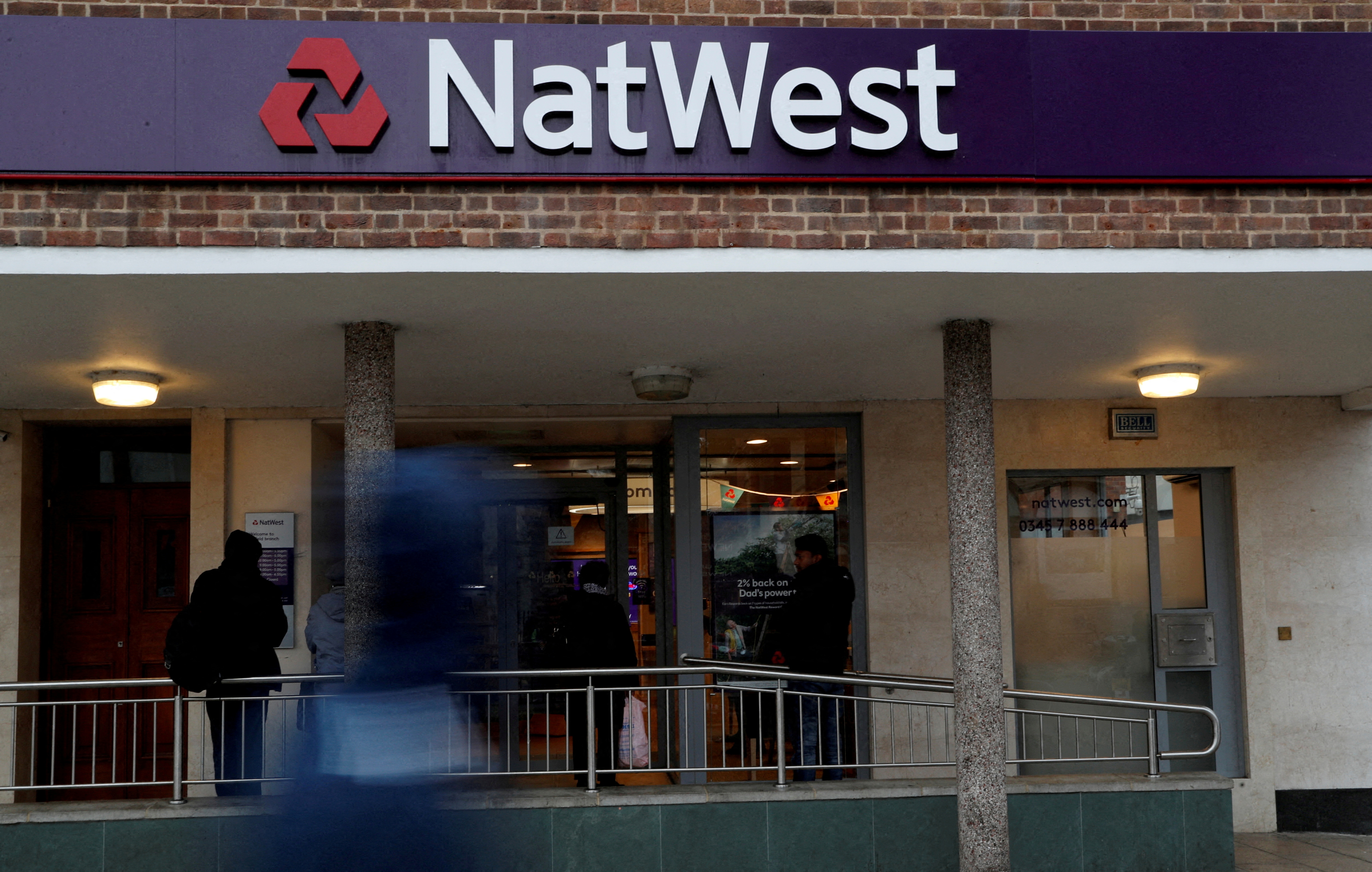 The logo of NatWest Bank is seen outside a branch in London