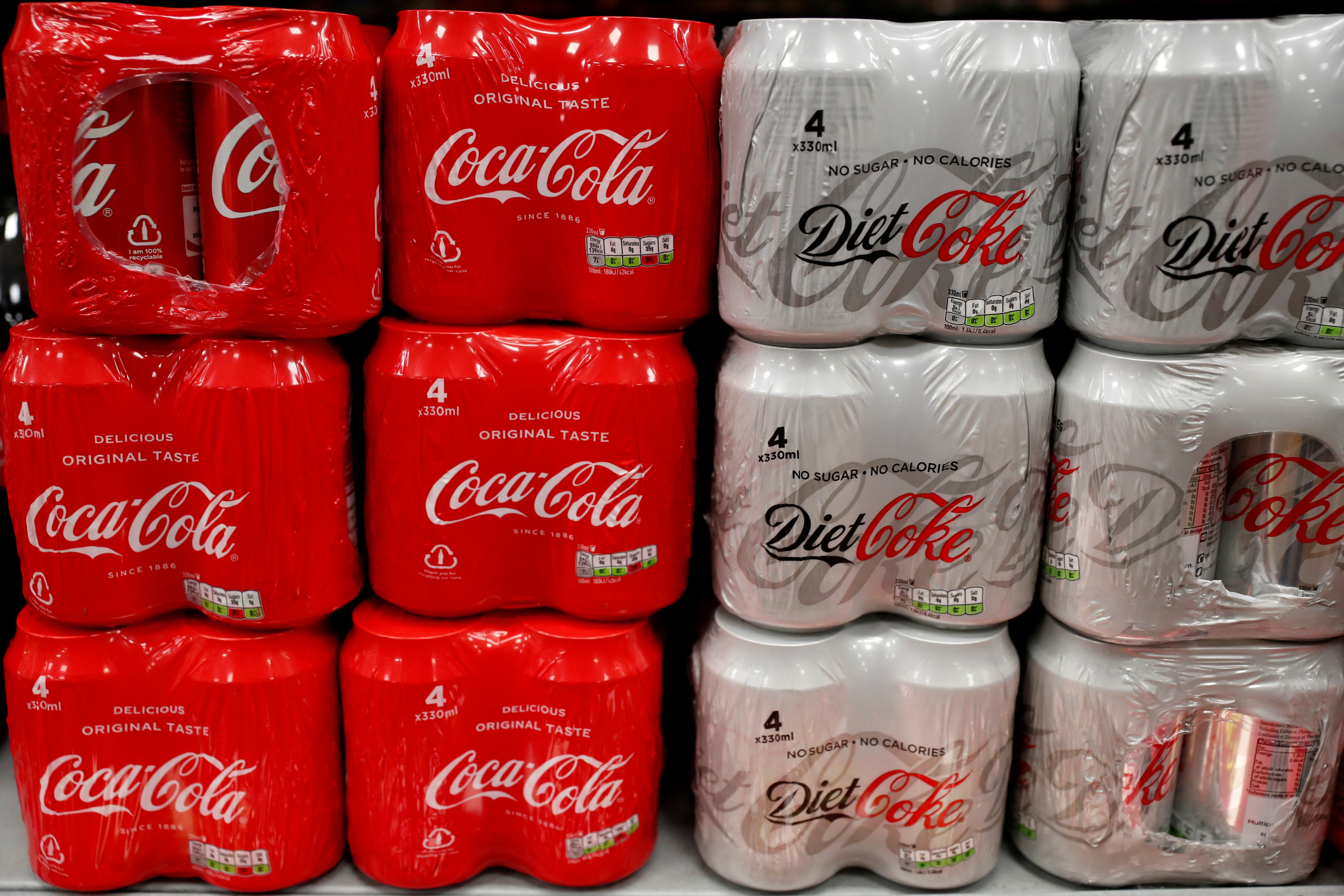 Multi can packs of Coca Cola and Diet Coke are seen for sale in a motorway services shop, Reading
