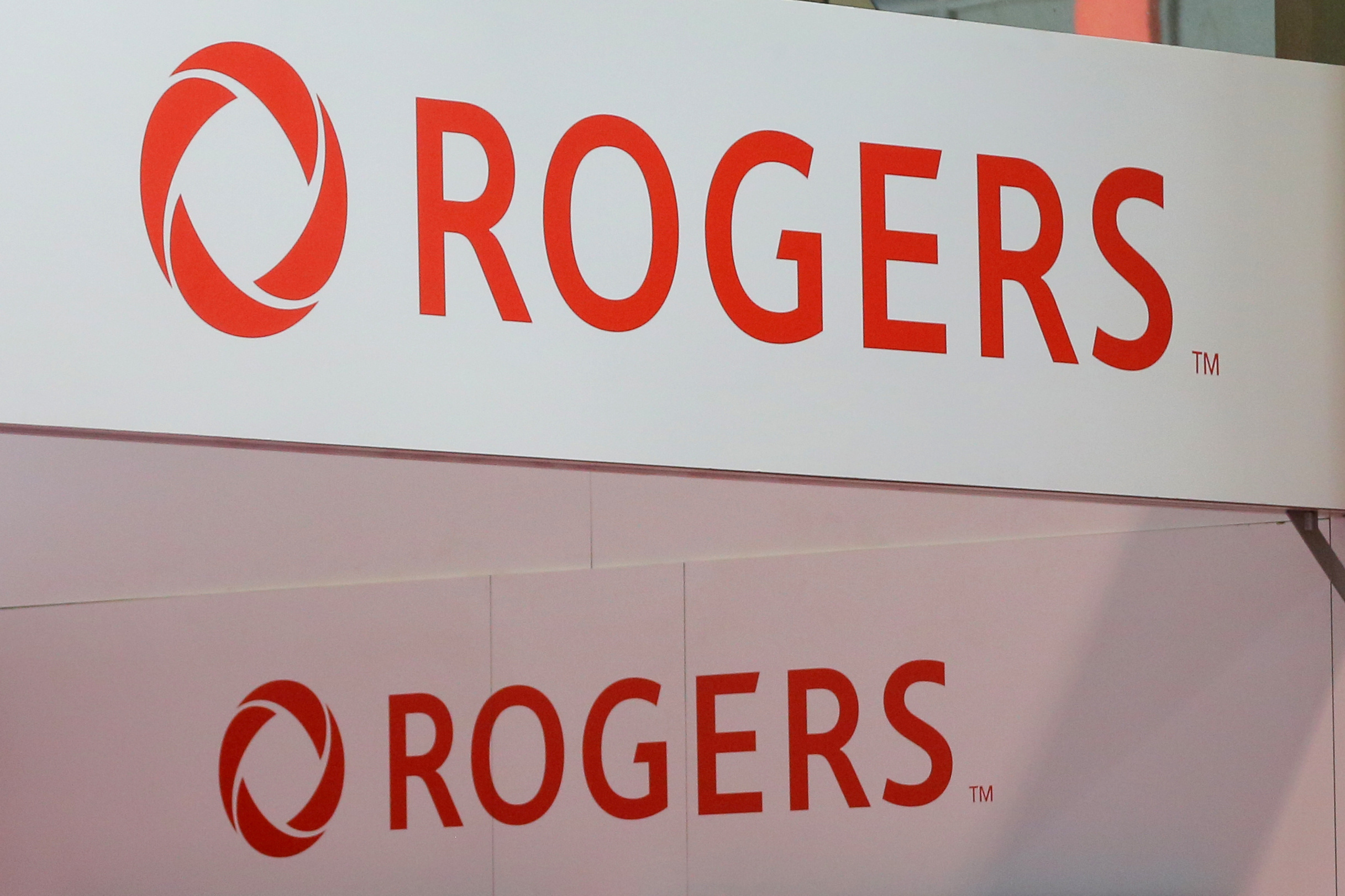 Rogers Communications logos are seen above a booth at the Canadian International AutoShow in Toronto