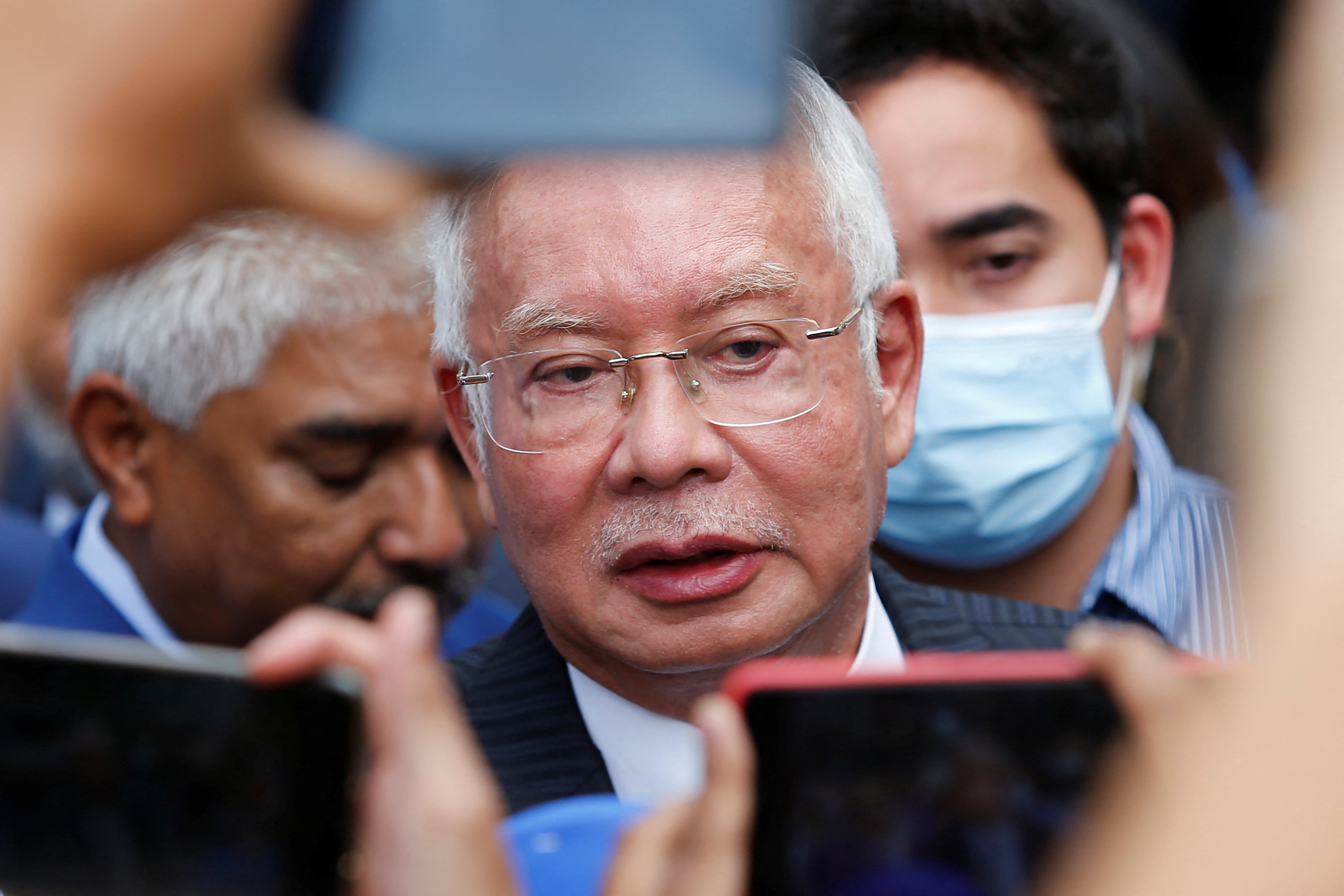 Former Malaysian Prime Minister Najib Razak speaks to journalists outside the Federal Court during a court break, in Putrajaya