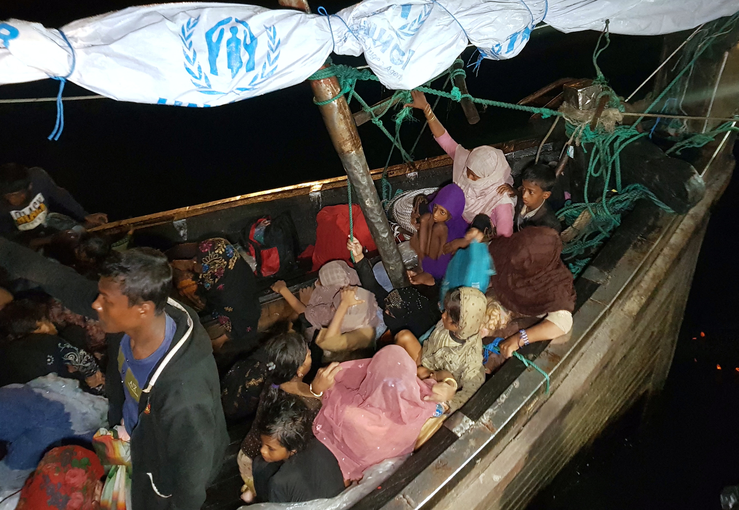 Rohingya refugees arrive by boat at a port in Lhokseumawe, Aceh