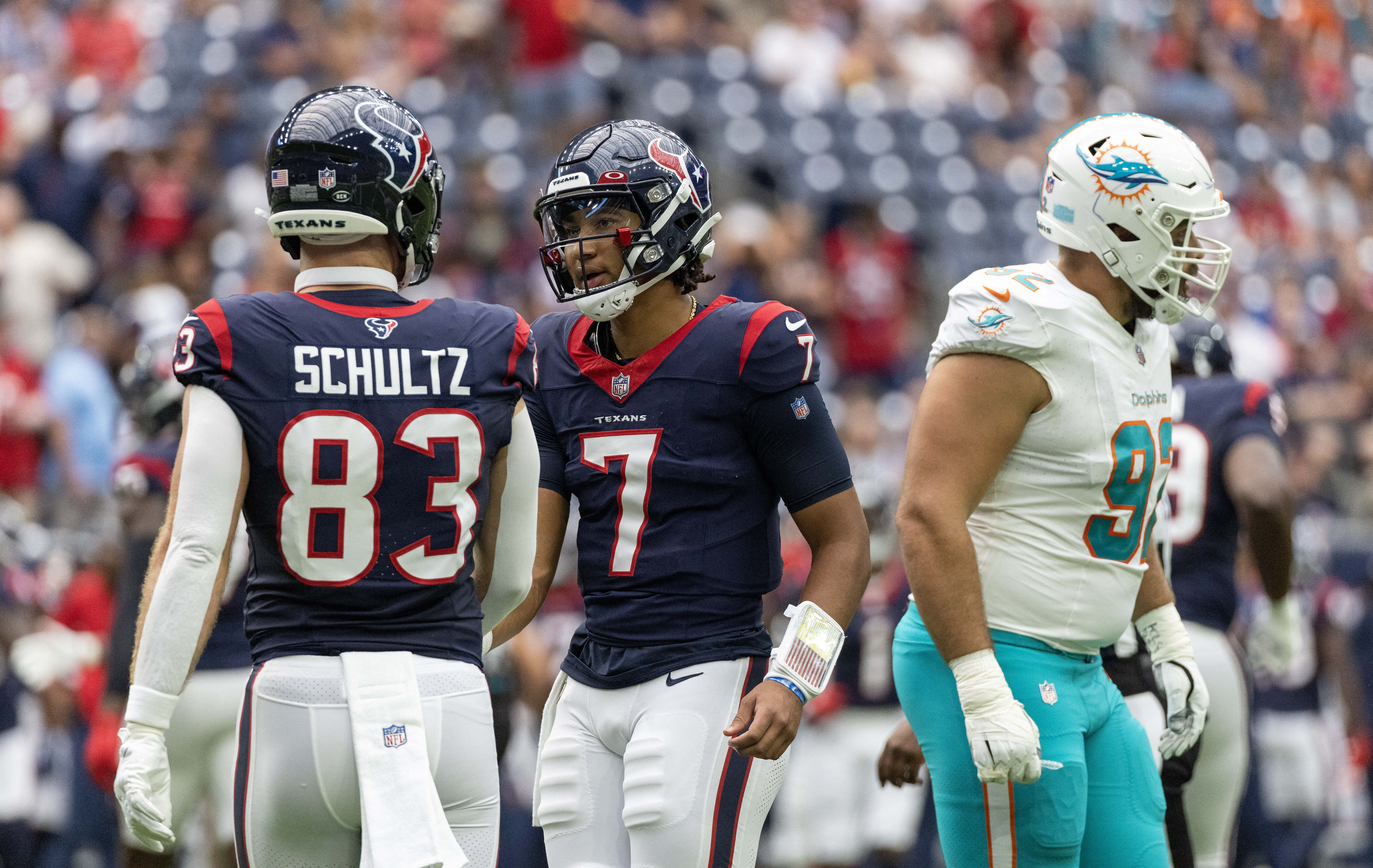 Miami Dolphins quarterback Skylar Thompson (19) and Miami Dolphins  quarterback Tua Tagovailoa (1) talk on the sidelines during an NFL football  game against the Houston Texans, Sunday, Nov. 27, 2022, in Miami