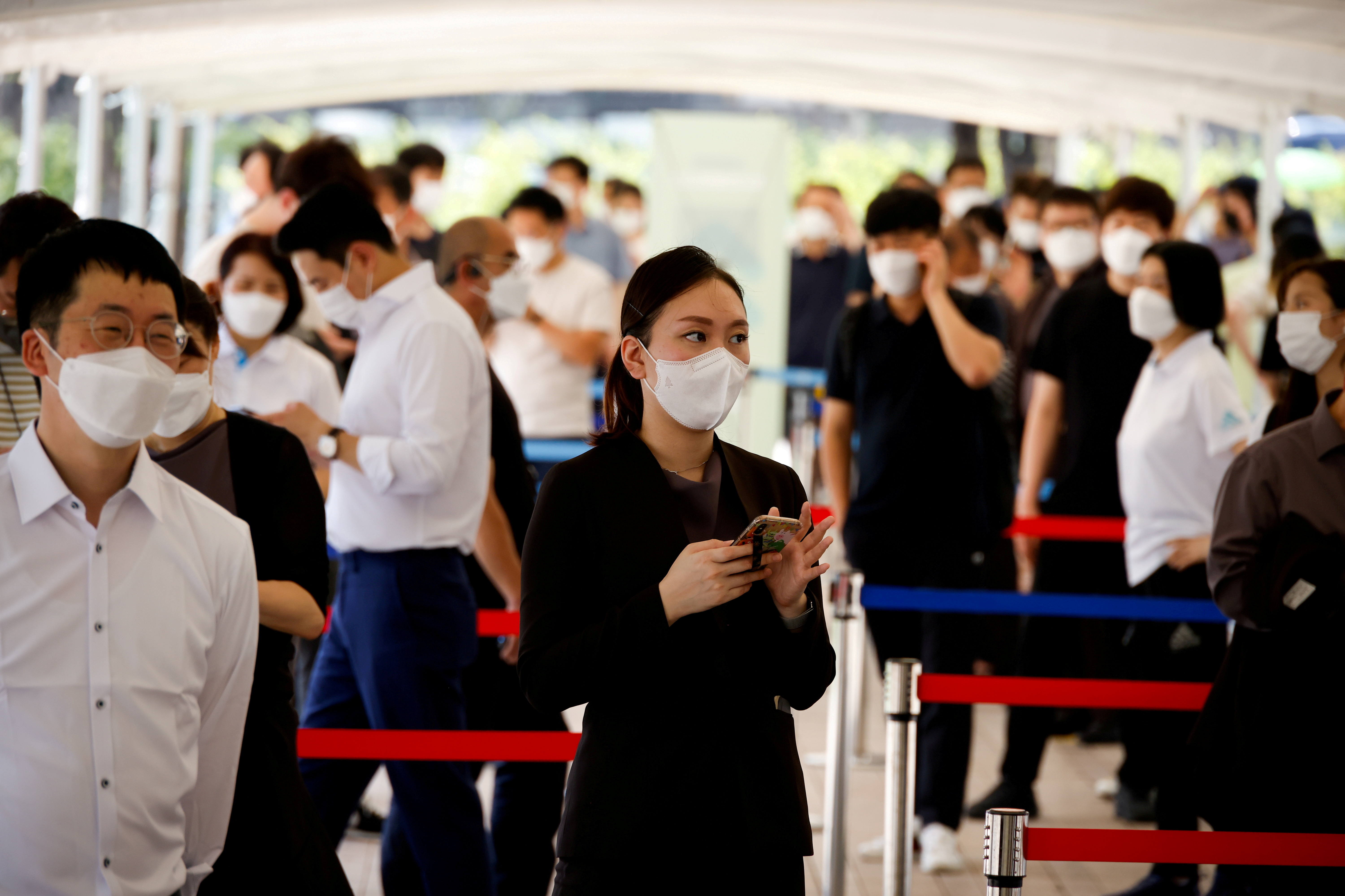 FILE PHOTO: People wait in line to get coronavirus disease (COVID-19) test at a coronavirus testing site in Seoul
