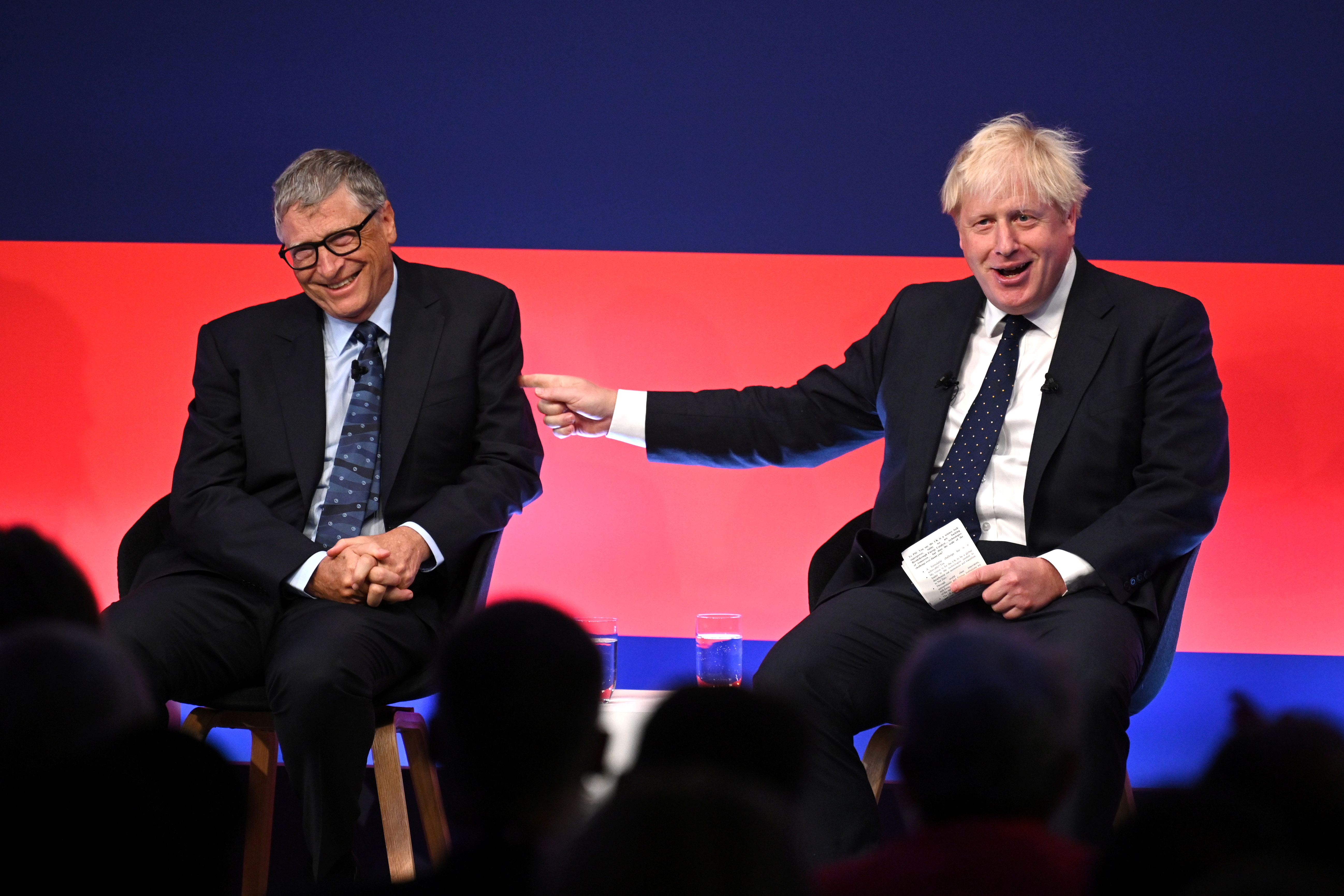 Britain's Prime Minister Boris Johnson appears on stage in conversation with Bill Gates during the Global Investment Summit at the Science Museum, in London, Britain, October 19, 2021. Leon Neal/Pool via REUTERS