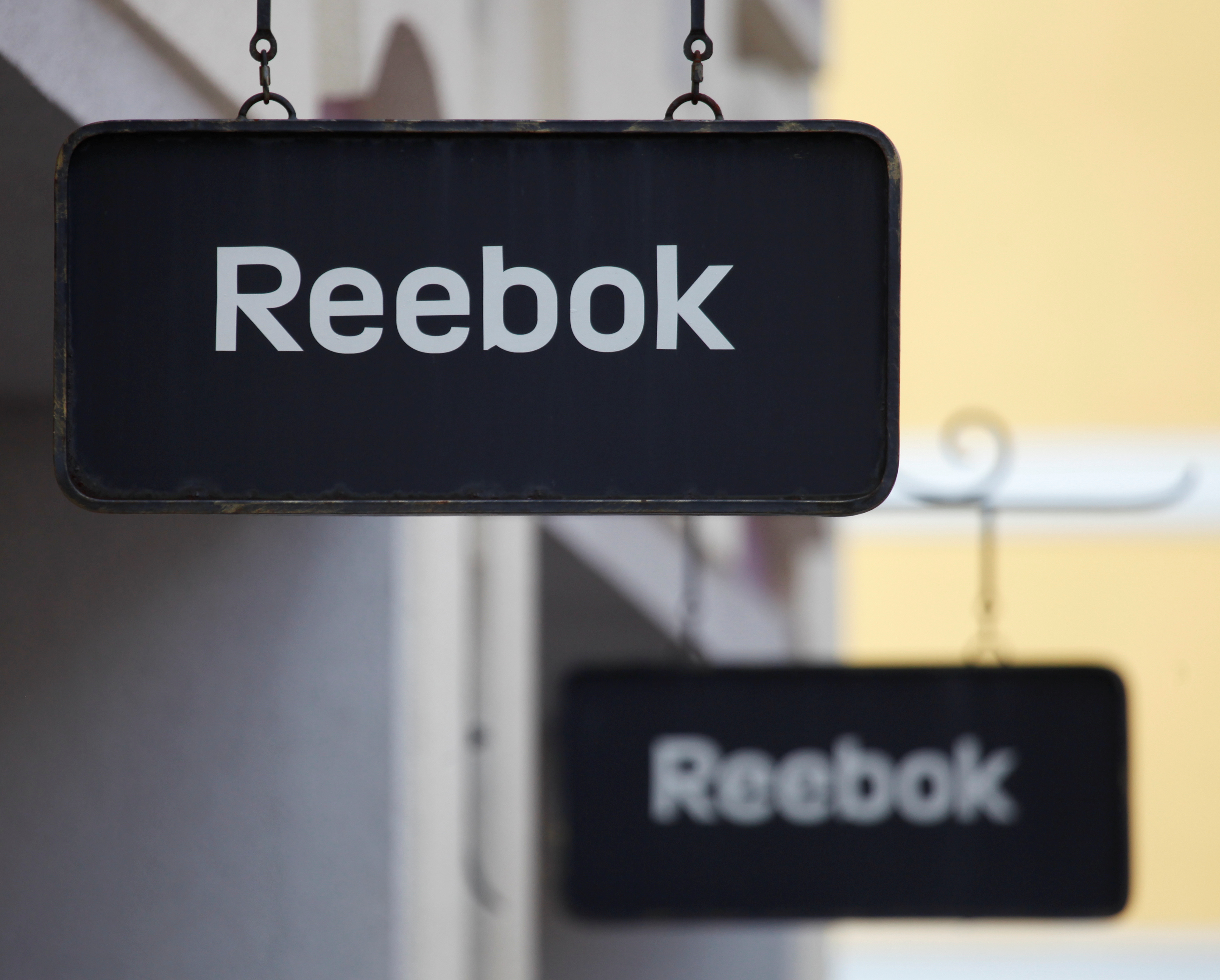Boards with Reebok store logo are seen on a shopping center at the outlet village Belaya Dacha outside Moscow