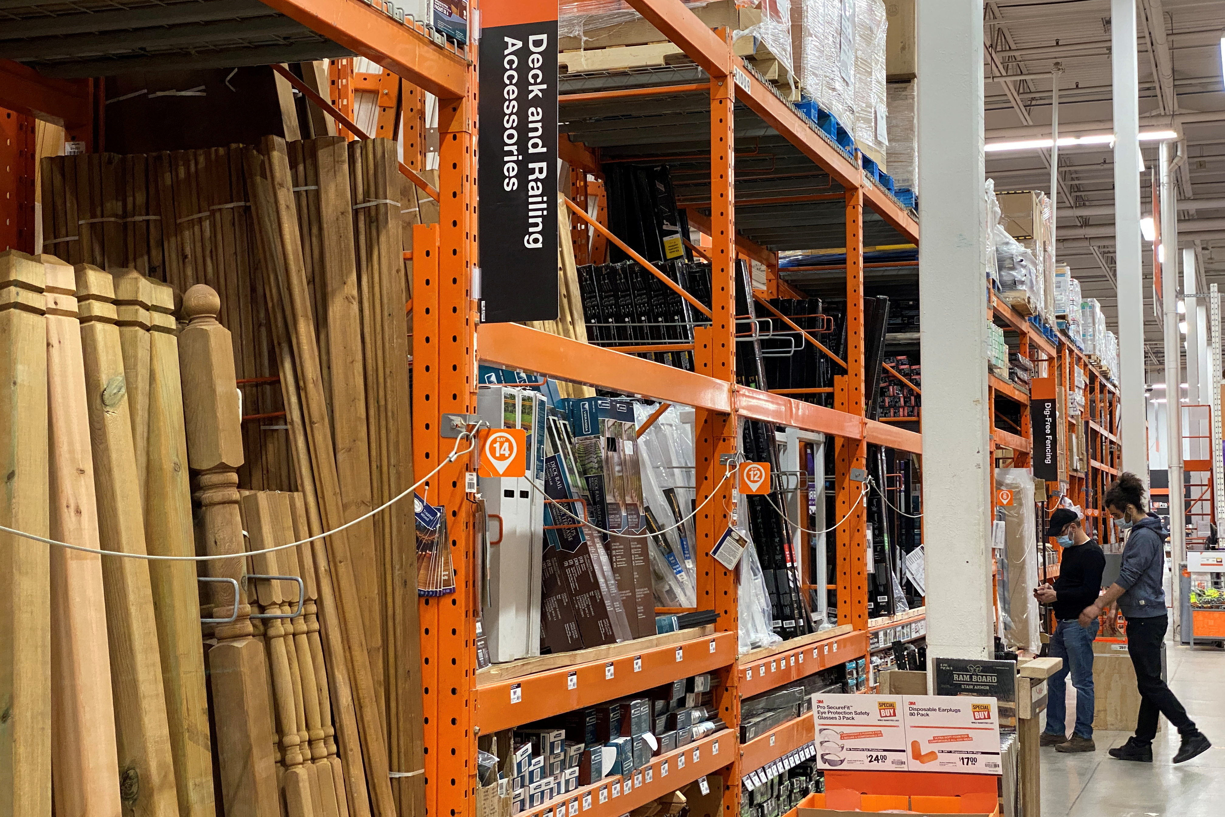 Customers browse among the decking supplies aisle in a Home Depot store in Toronto