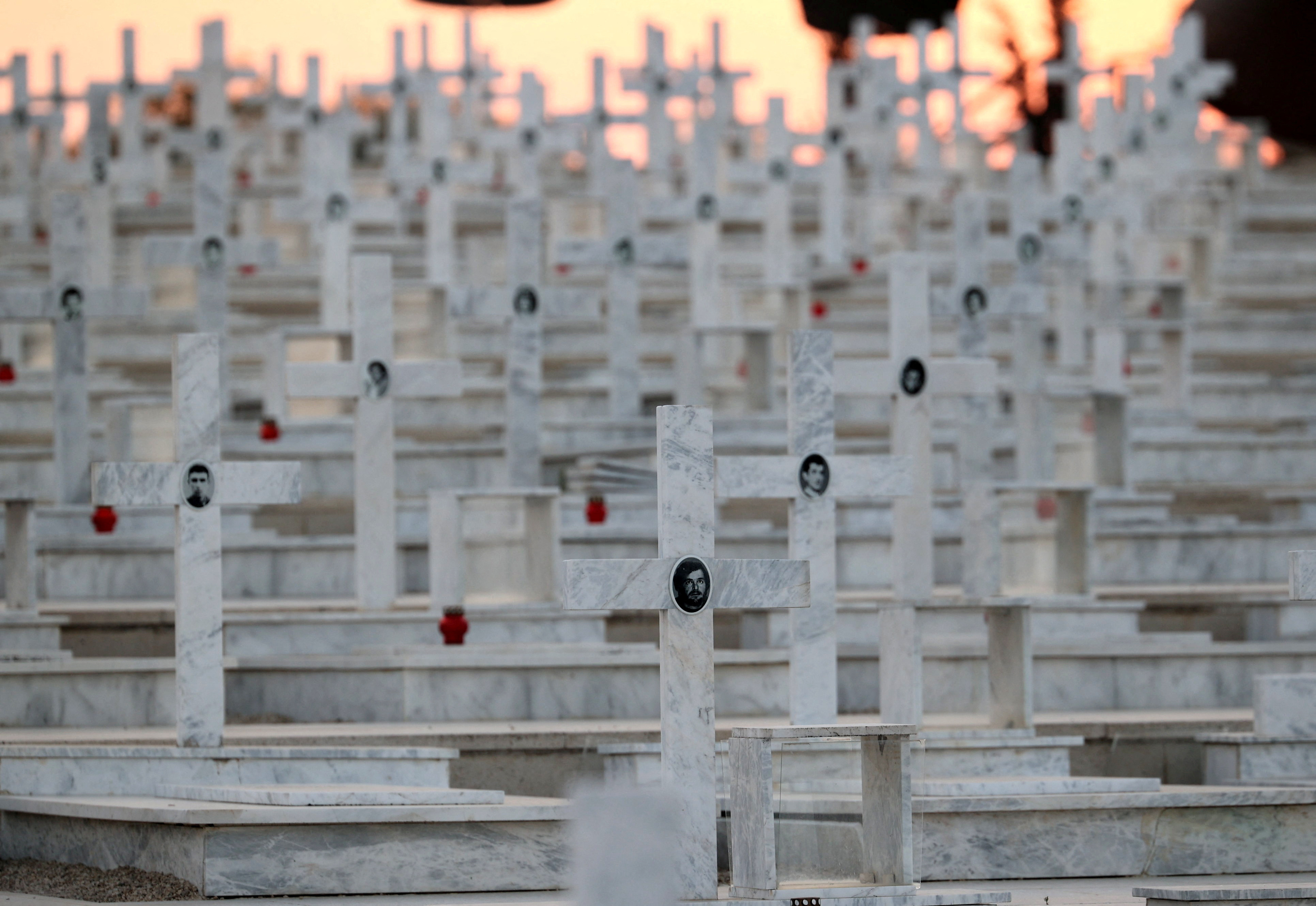 Pictures of soldiers killed in the 1974 Turkish invasion of Cyprus are seen on crosses at the Tymvos Makedonitissas military cemetery in Nicosia