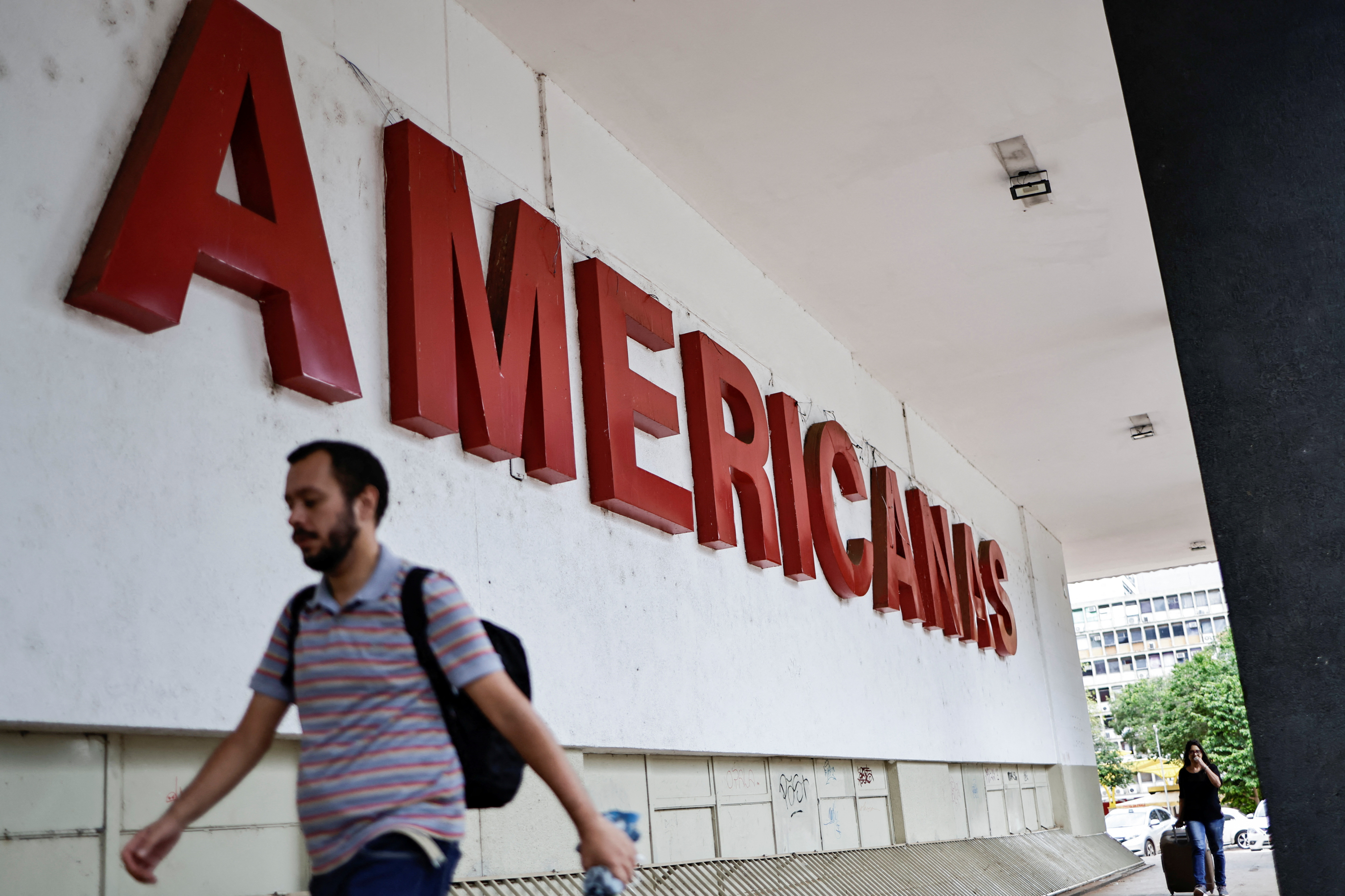 People walk in front of a Lojas Americanas store in Brasilia