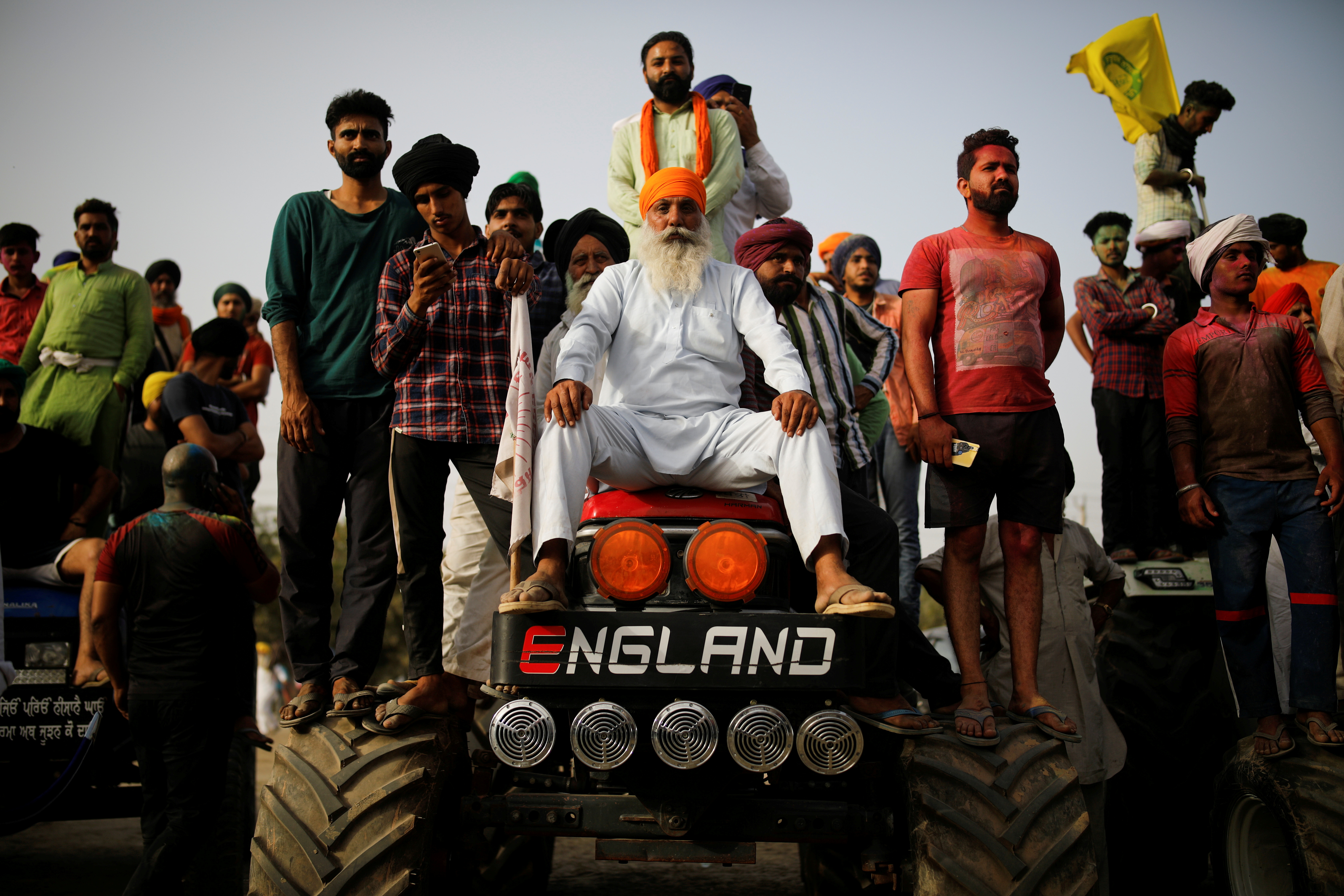Farmers watch Nihangs, or Sikh warriors, perform near New Delhi