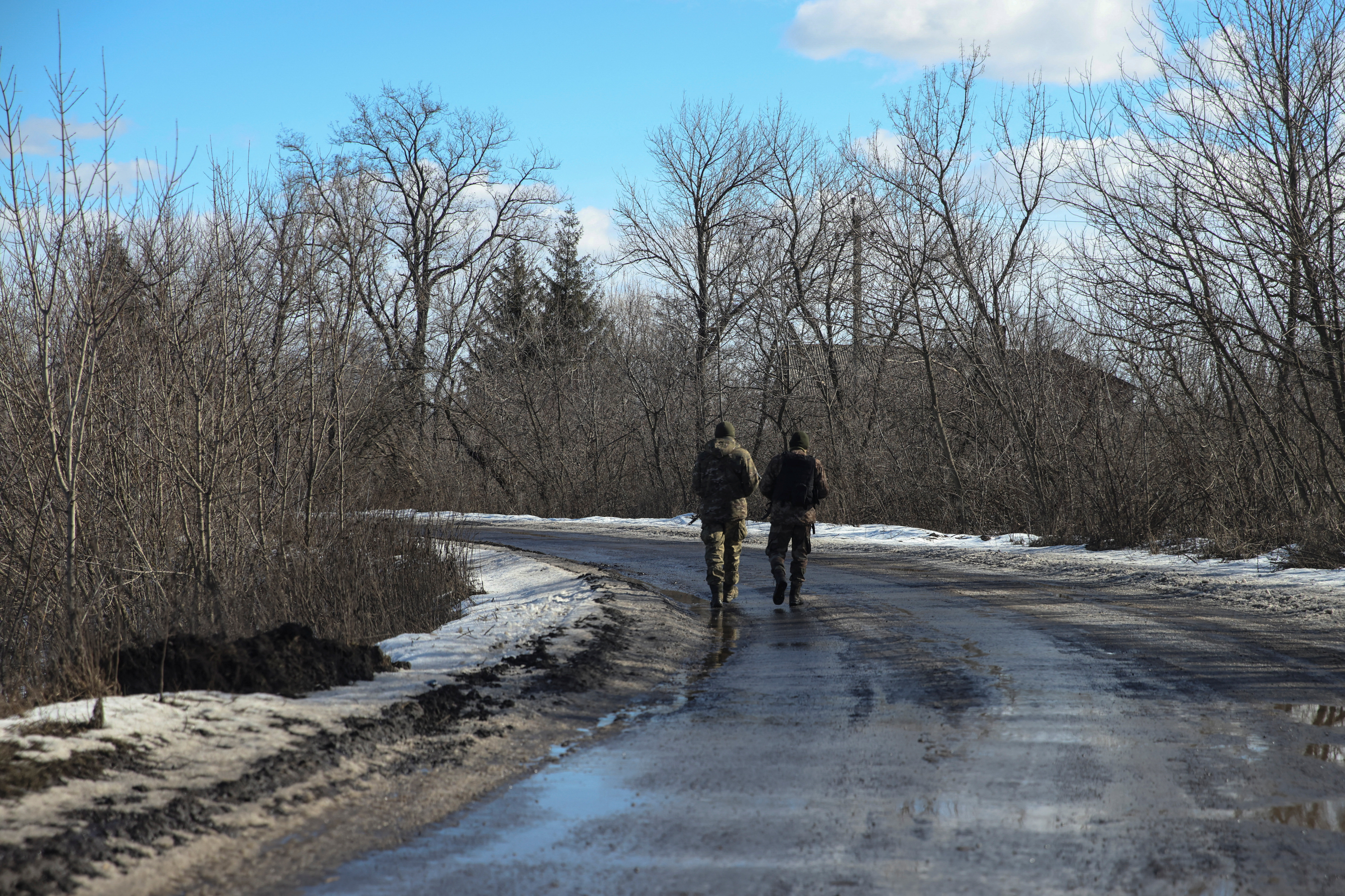 Ukrainian service members patrol an area in the town of Siversk