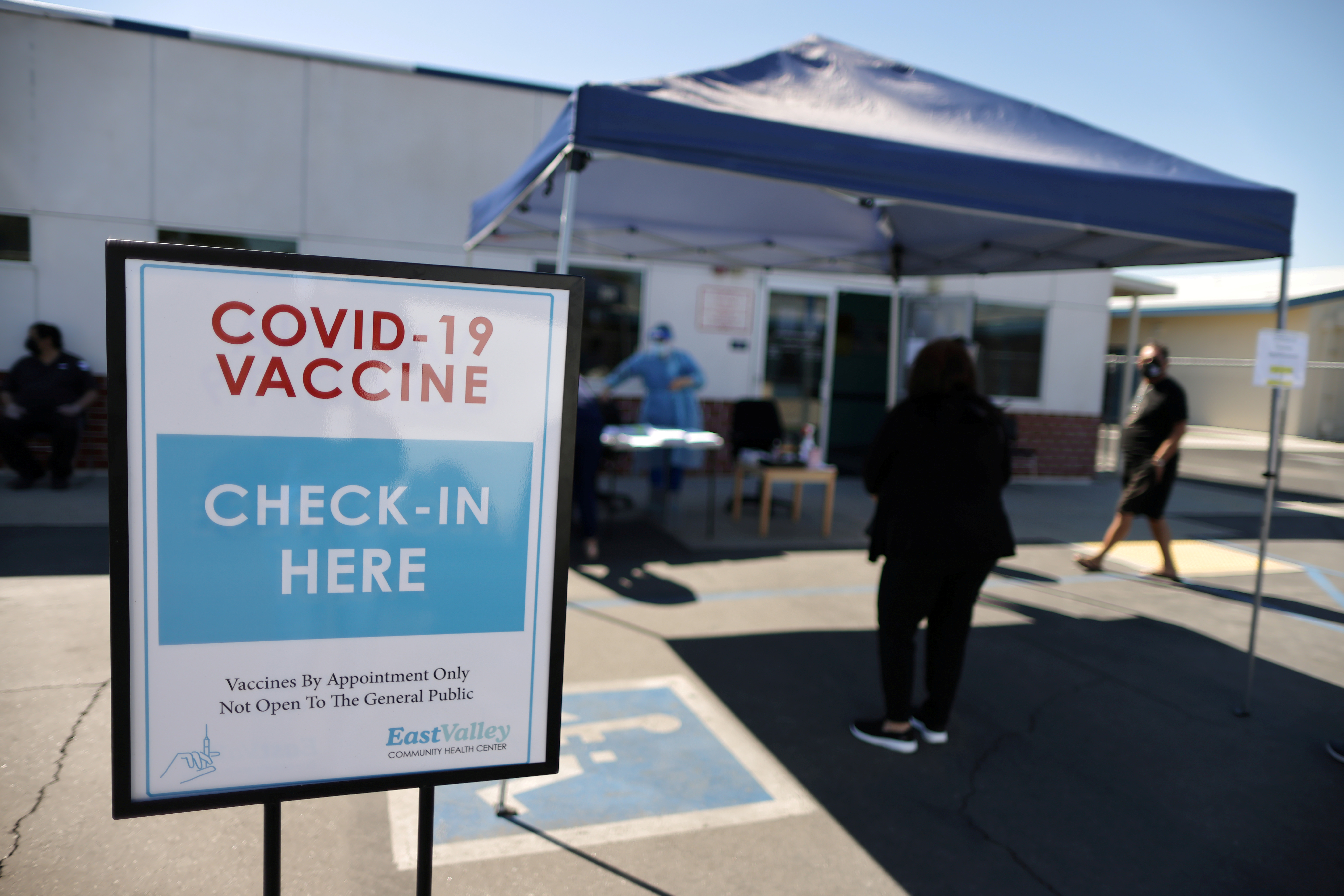 People arrive for coronavirus disease (COVID-19) vaccinations, at East Valley Community Health Center in La Puente