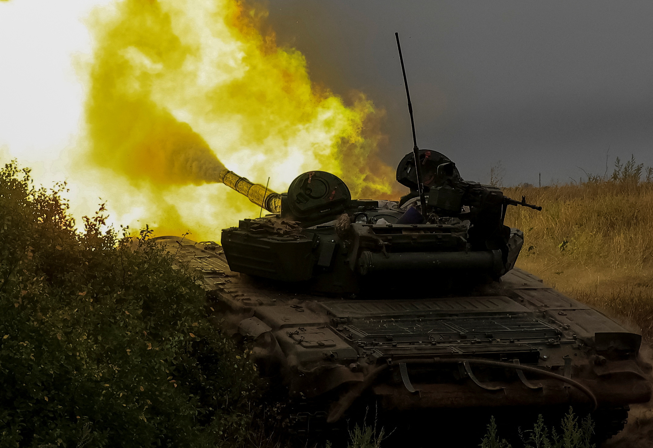 Ukrainian servicemen fire toward Russian troops with a tank at a position in Donetsk region