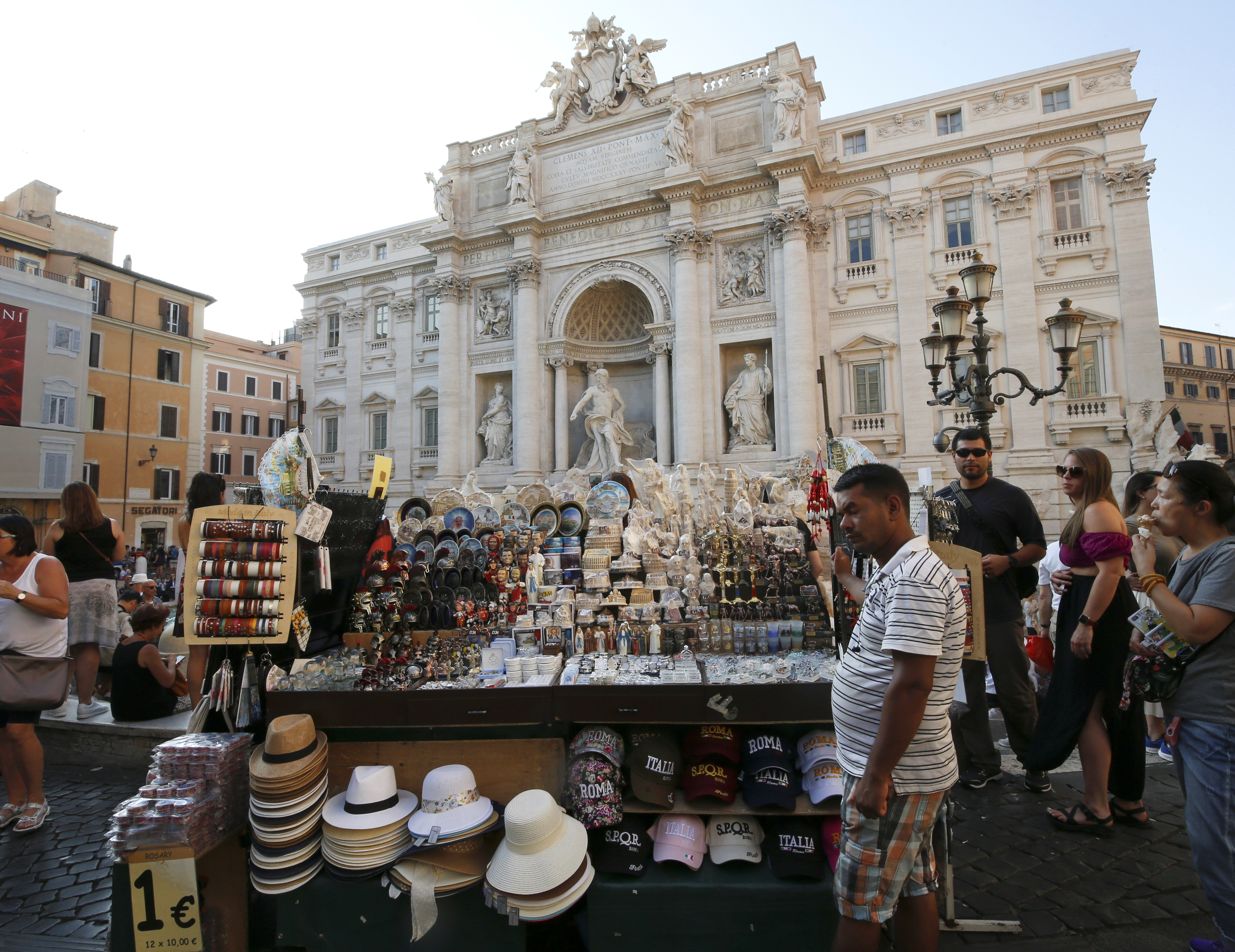 A vendor sells souvenirs at Trevi Fountain in Rome
