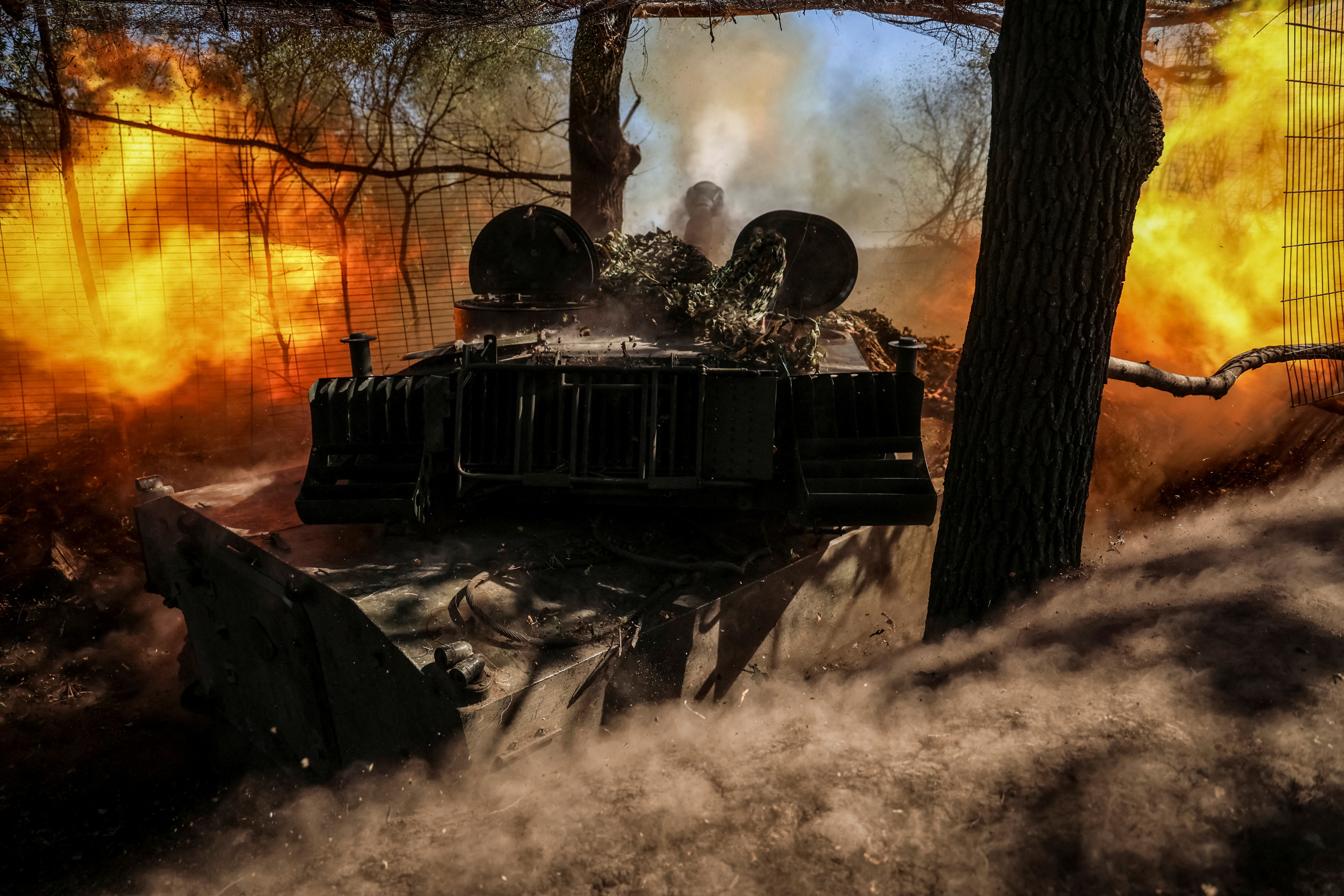 Ukrainian servicemen fire a self propelled howitzer towards Russian troops in Donetsk region