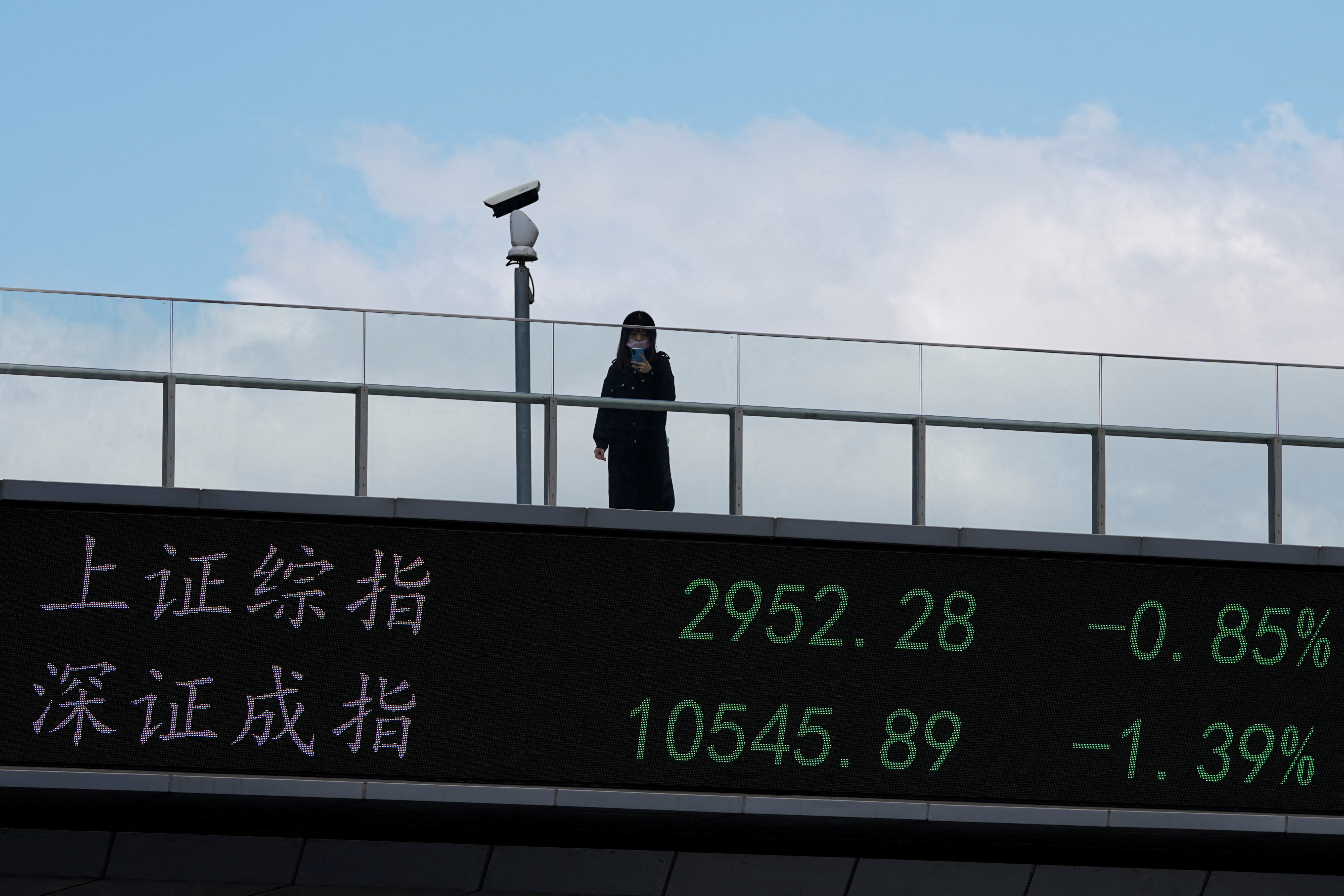 An electronic board shows Shanghai and Shenzhen stock indexes in Shanghai