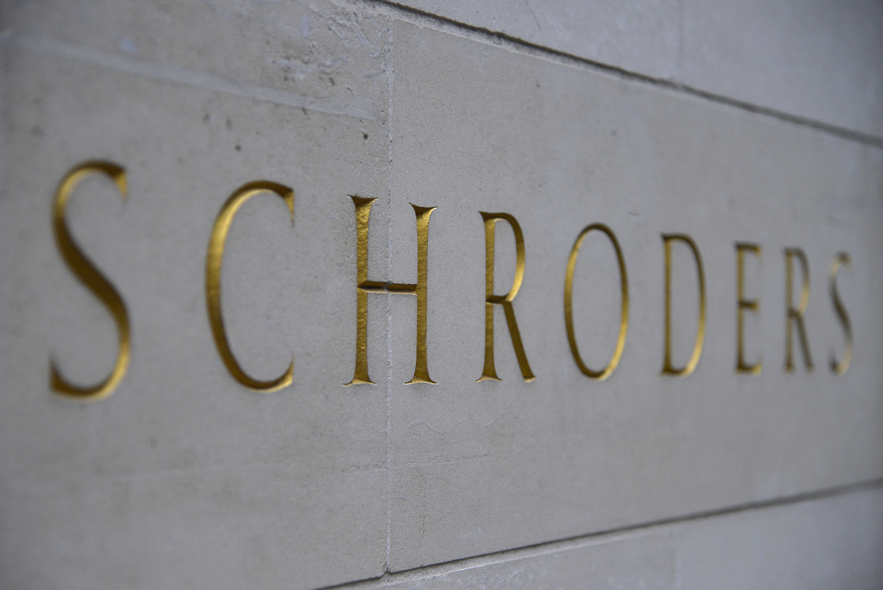 A Schroders sign is seen outside a building in the City of London