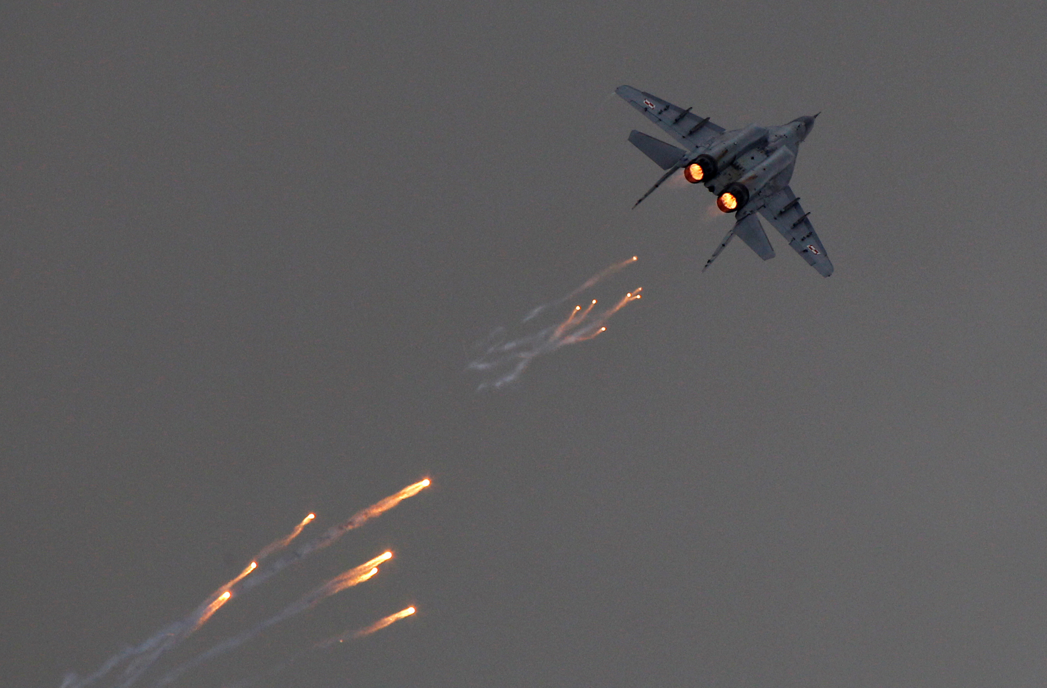 A Polish Air Force MiG-29 aircraft fires flares during a performance at the Radom Air Show at an airport in Radom