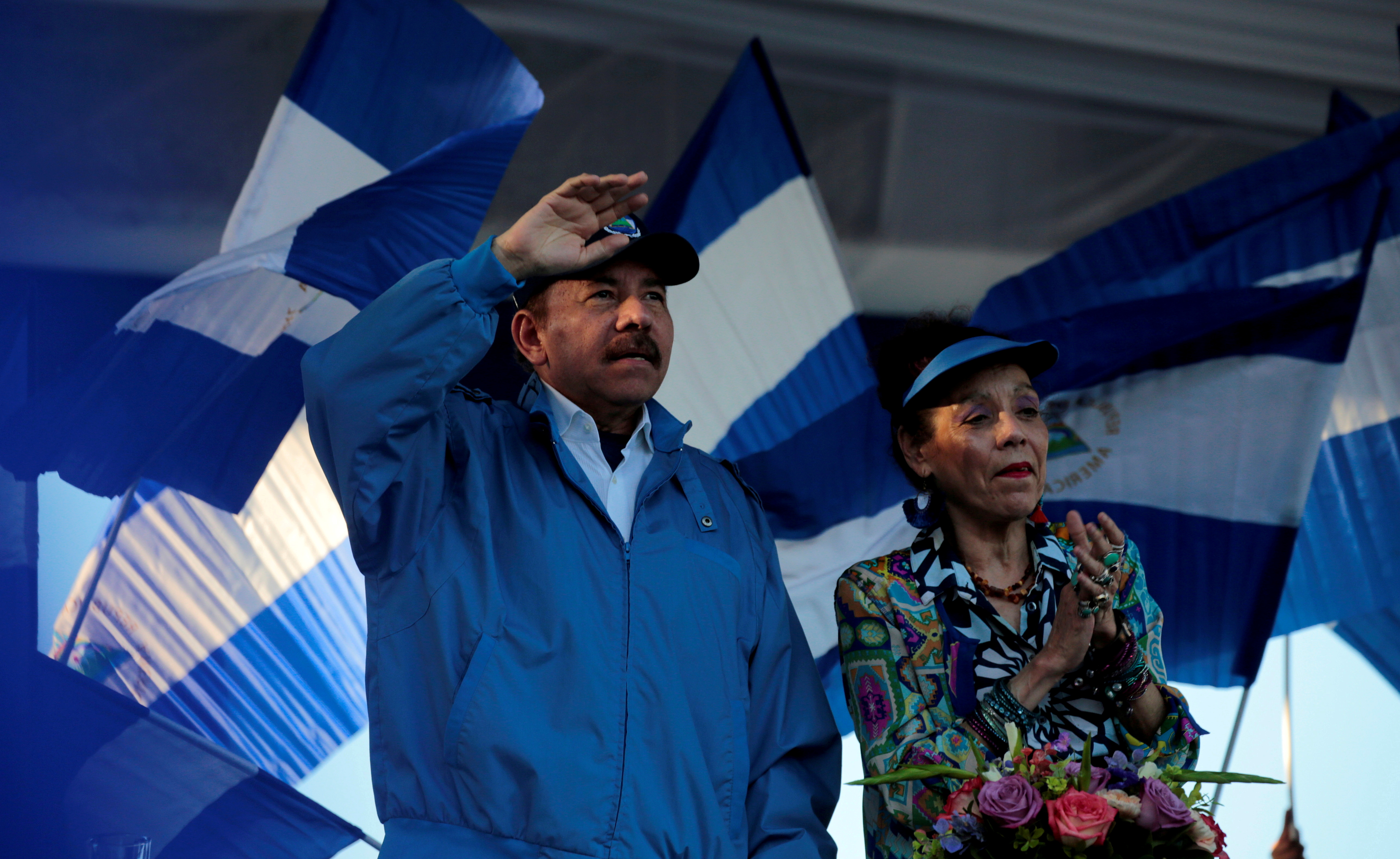 Nicaraguan President Ortega and Vice President Murillo gesture during a march in Managua