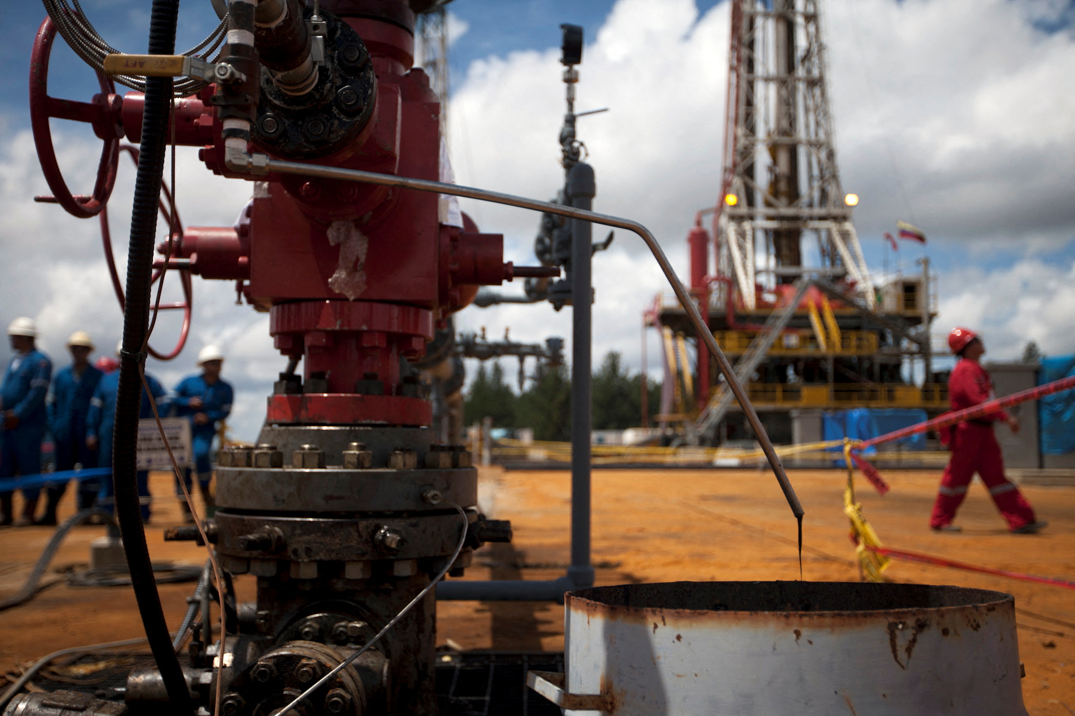 Crude oil drips from a valve at an oil well operated by Venezuela's state oil company PDVSA in Morichal