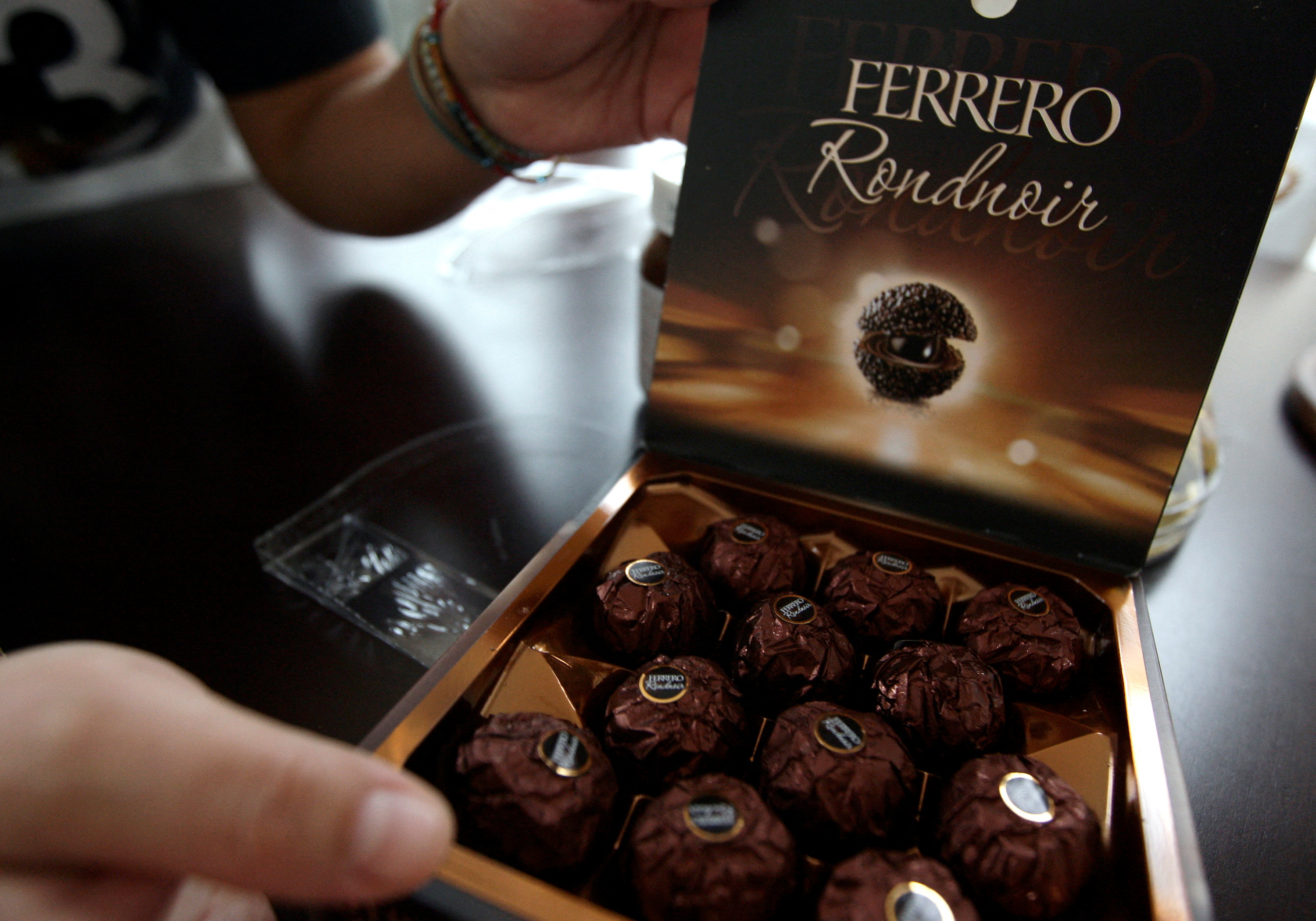 A woman displays a Ferrero chocolate box in Milan