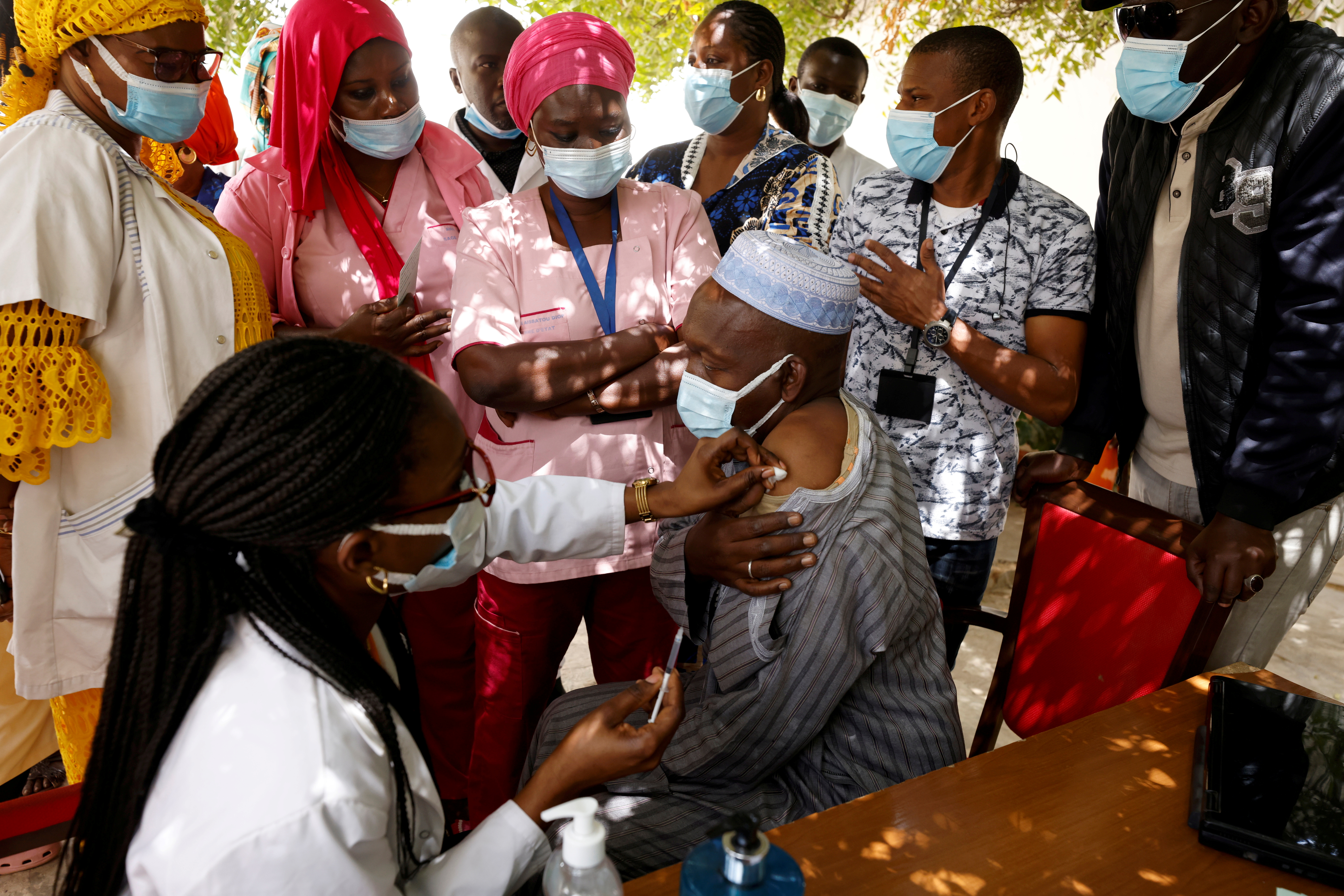 A health worker receives a dose of coronavirus disease (COVID-19) vaccine in Dakar
