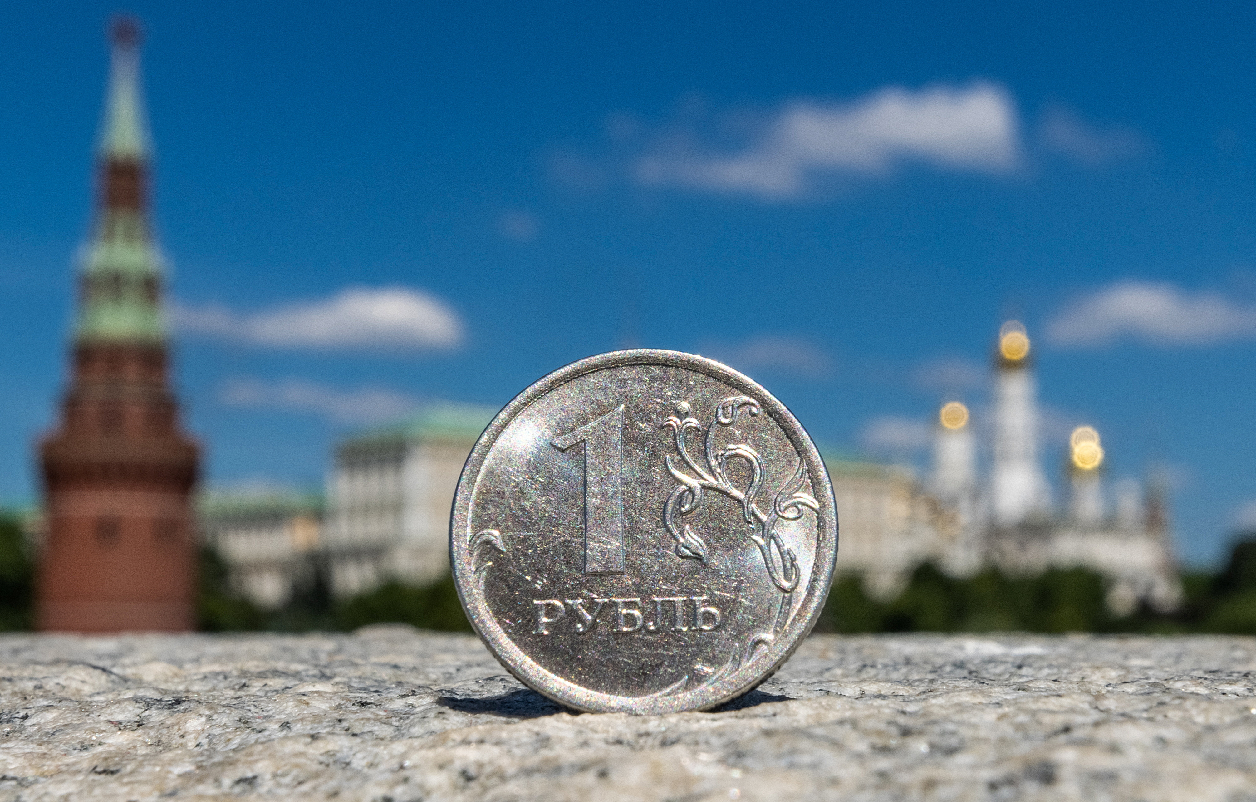 A Russian one rouble coin is pictured in front of the Kremlin in Moscow