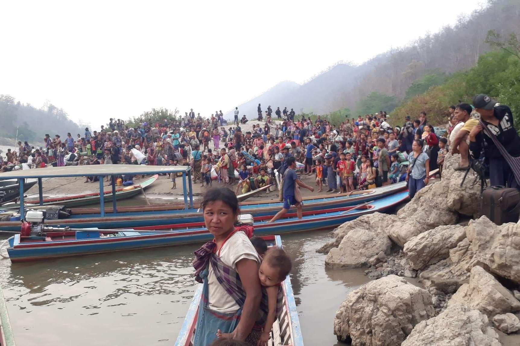 Karen refugees carrying belongings are seen at Salween riverbank in Mae Hong Son