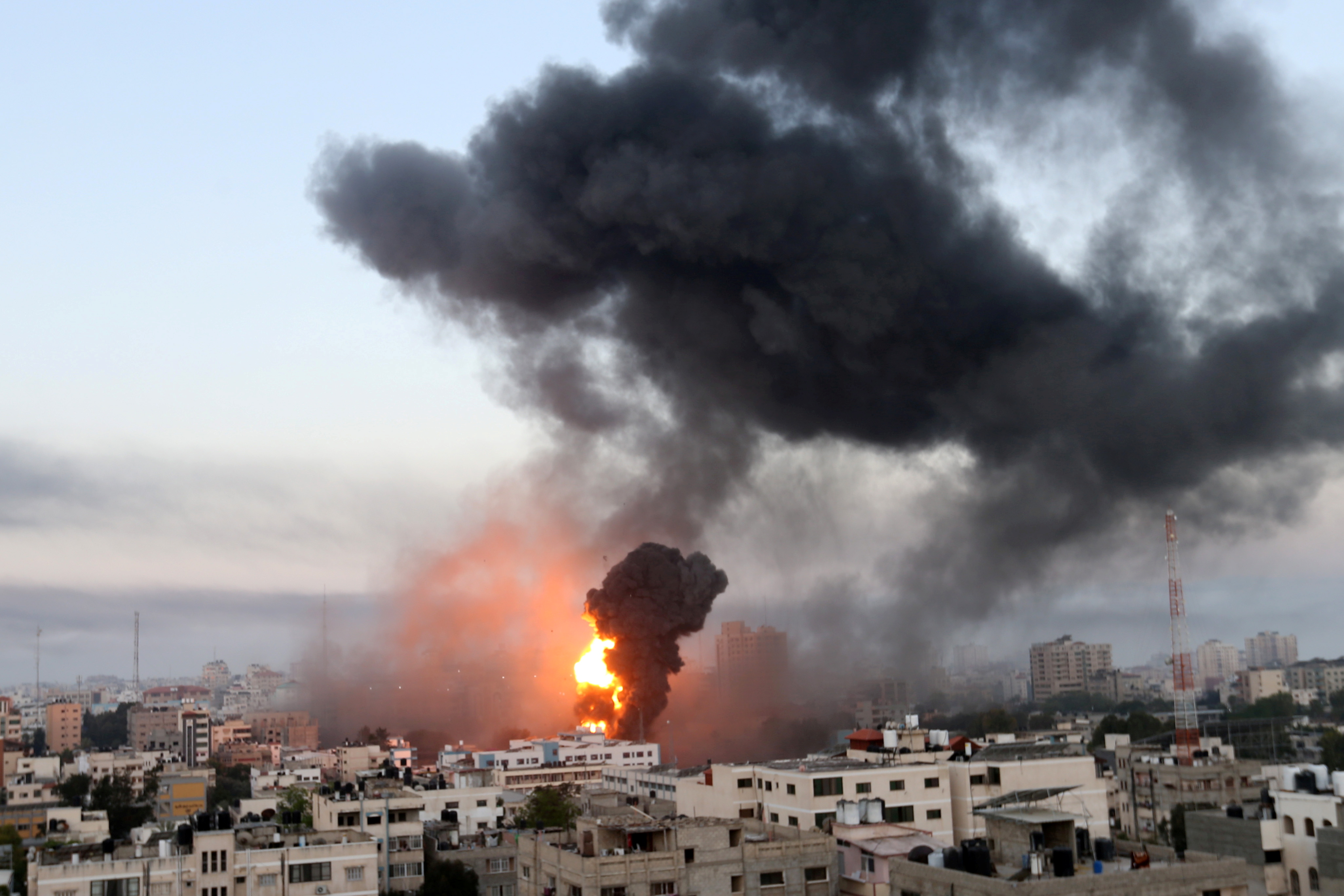 Smoke and flames rise during Israeli air strikes amid a flare-up of Israeli-Palestinian violence, in Gaza May 12, 2021. REUTERS/Ibraheem Abu Mustafa