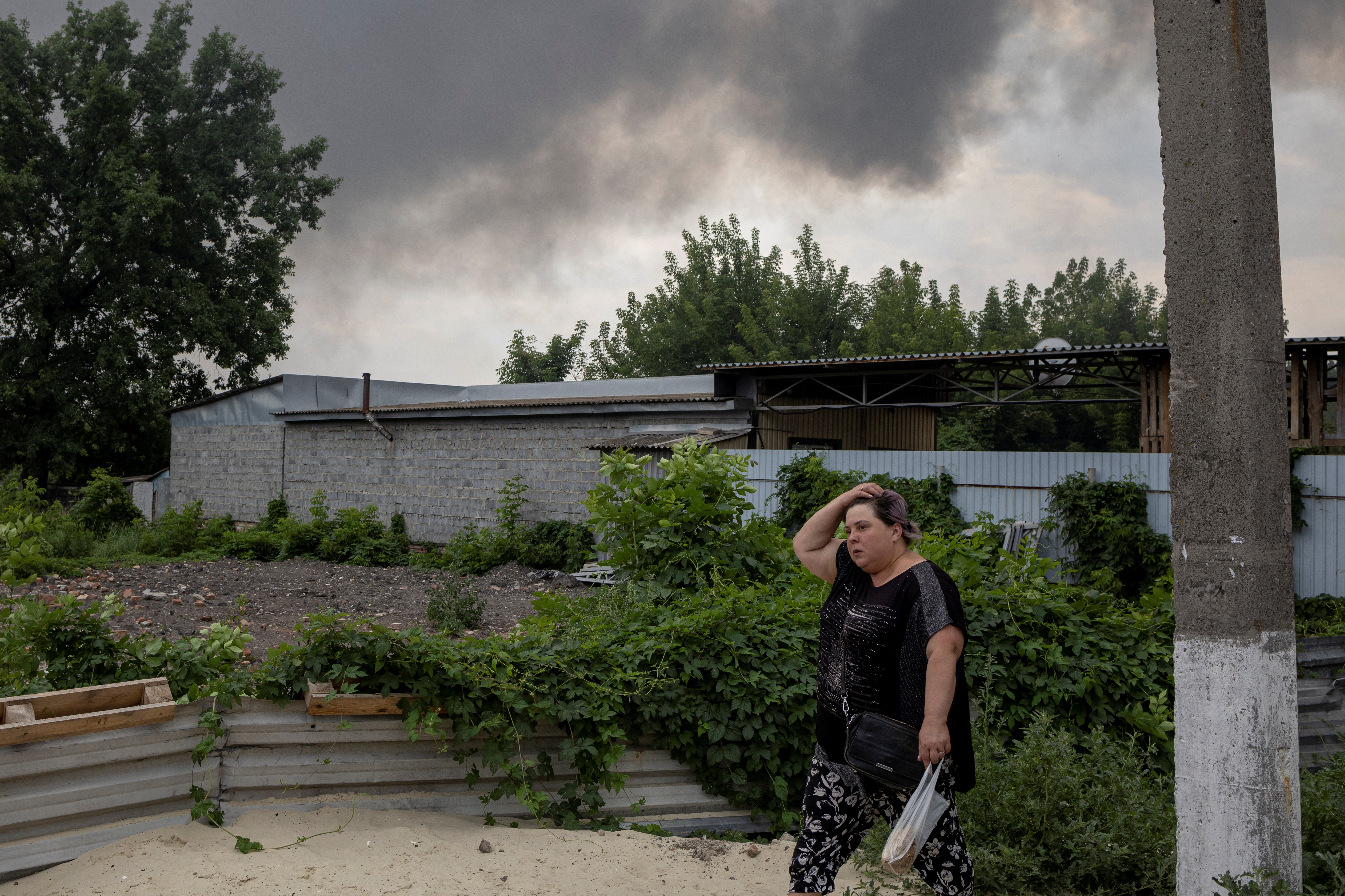 A woman walks past the market after shelling in Sloviansk