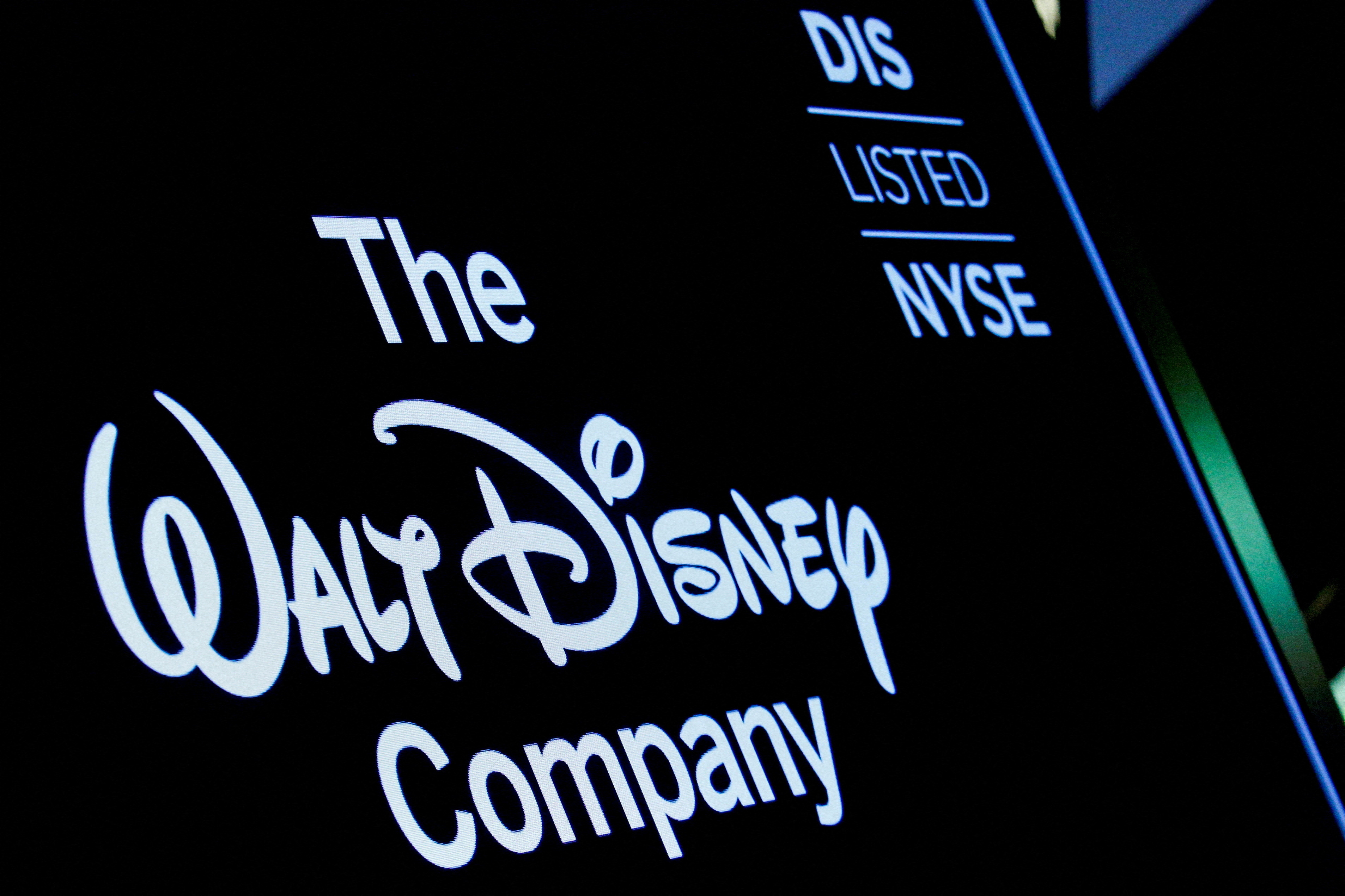 A screen shows the trading info for Walt Disney Company company on the floor of the NYSE in New York