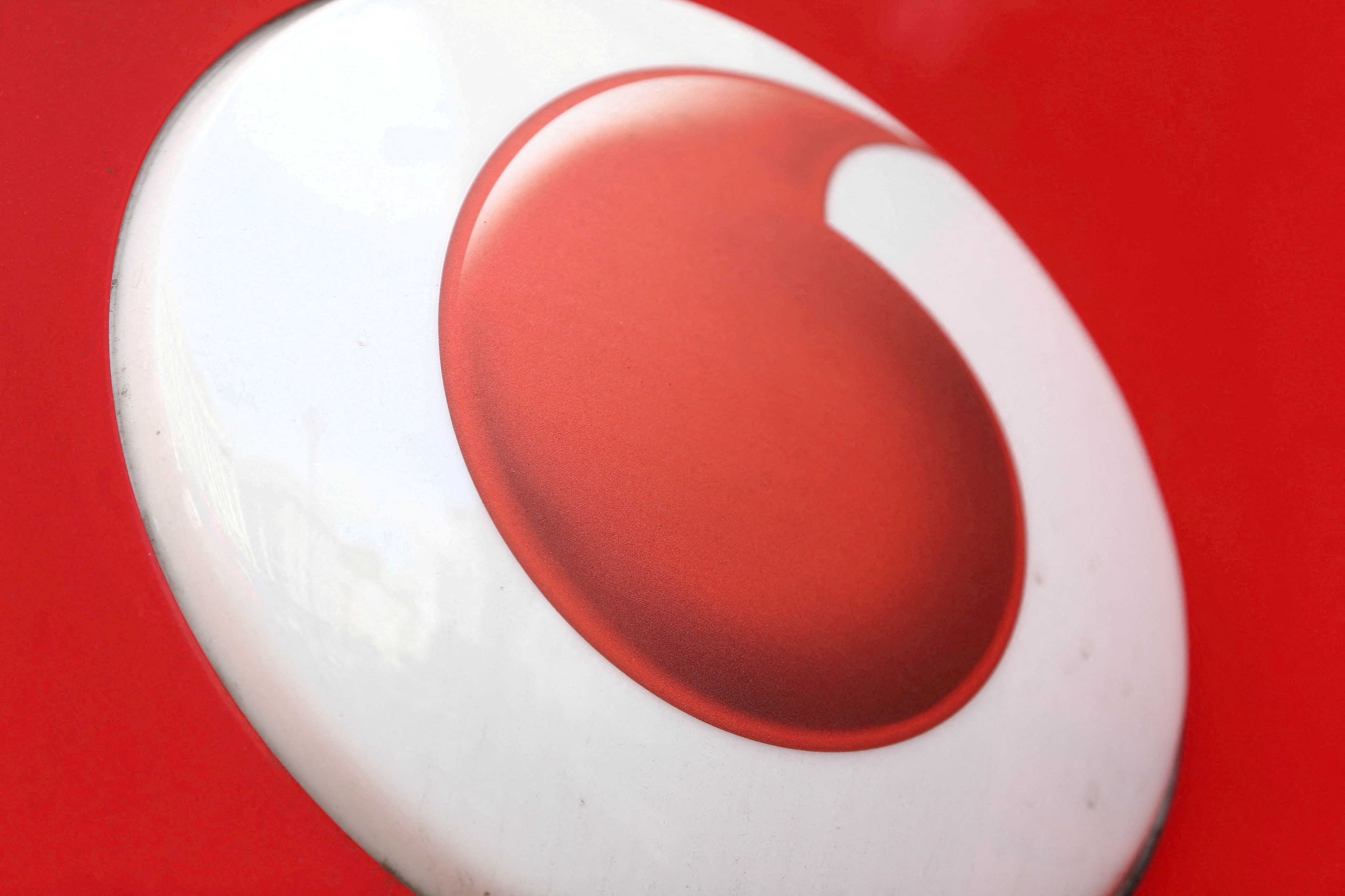 A branded sign is displayed on a Vodafone store in London