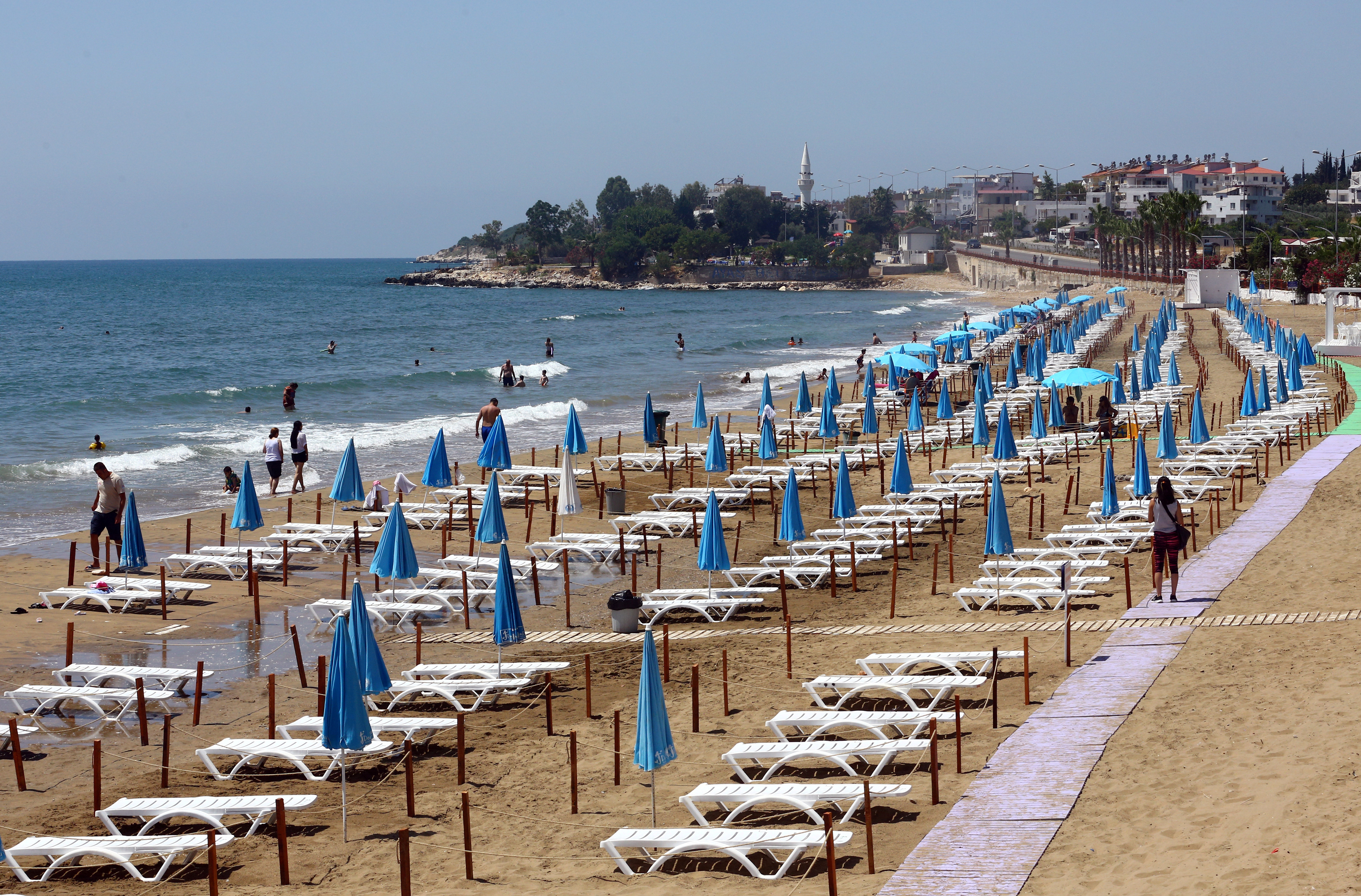 Sunbeds are aligned respecting social distancing on the Yemis Kumu beach near Mersin