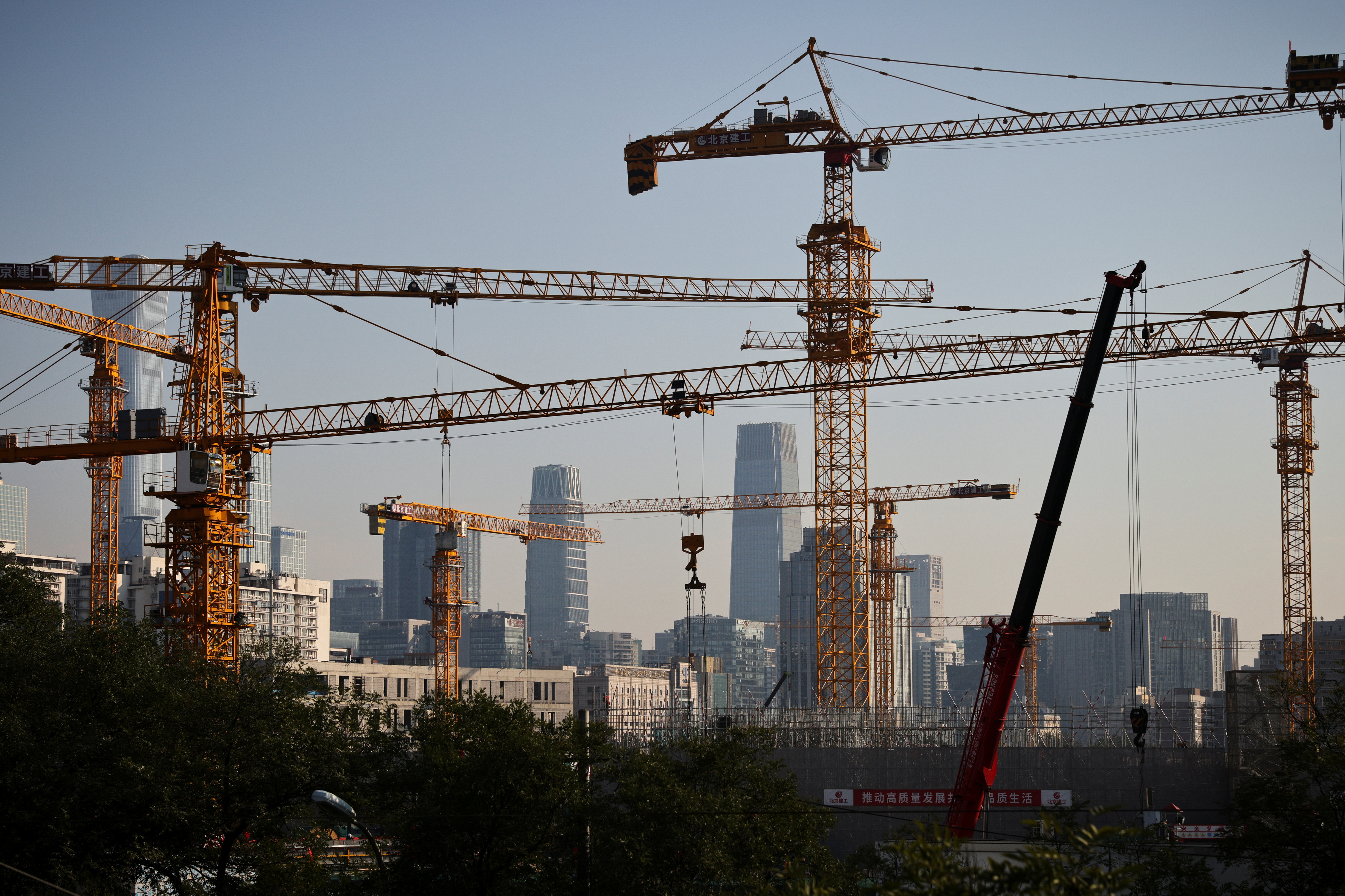 A view shows cranes in front of the skyline of the Central Business District (CBD) in Beijing
