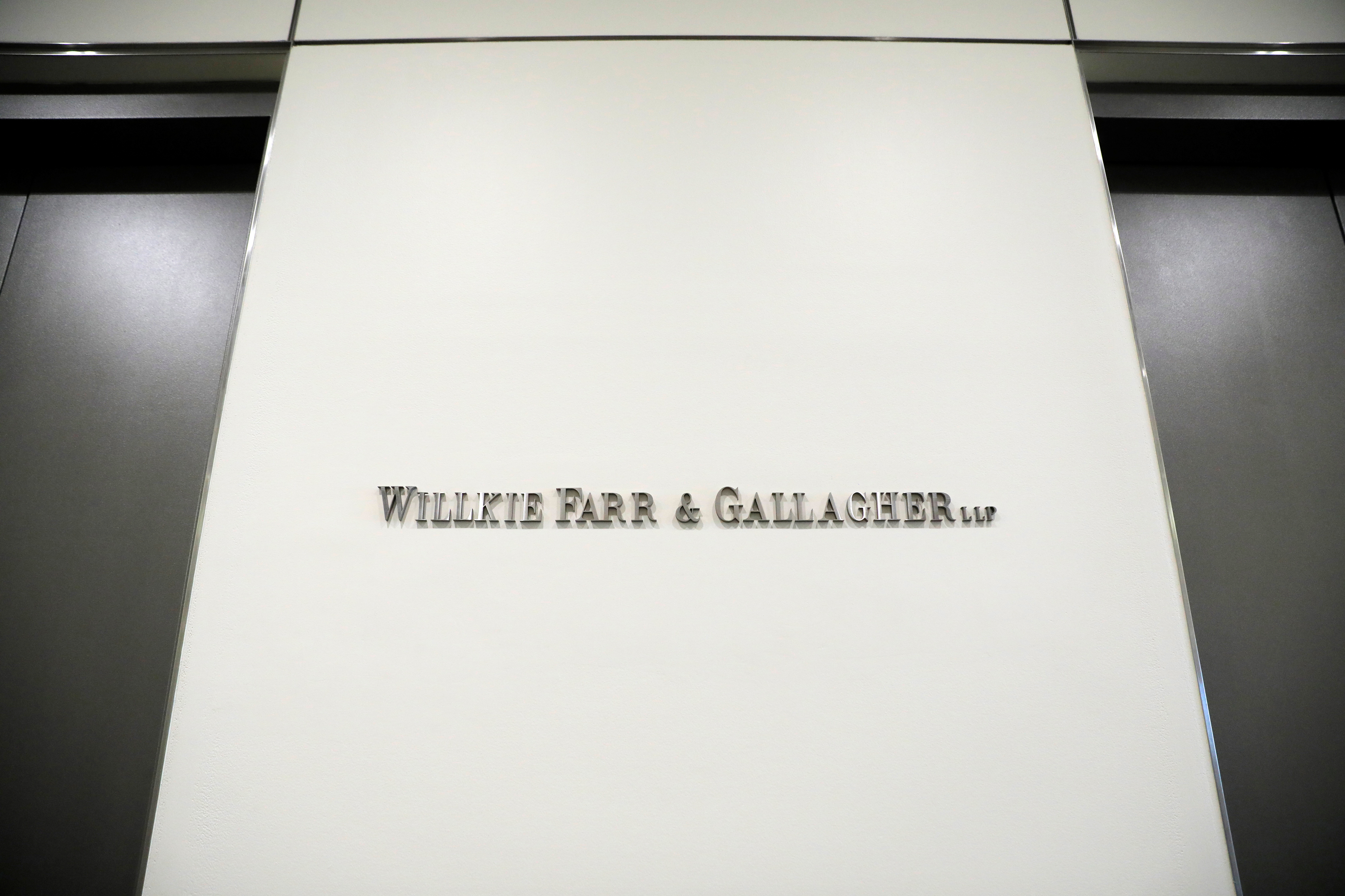 Signage is seen at the legal offices of the law firm Willkie Farr & Gallagher in New York City, New York