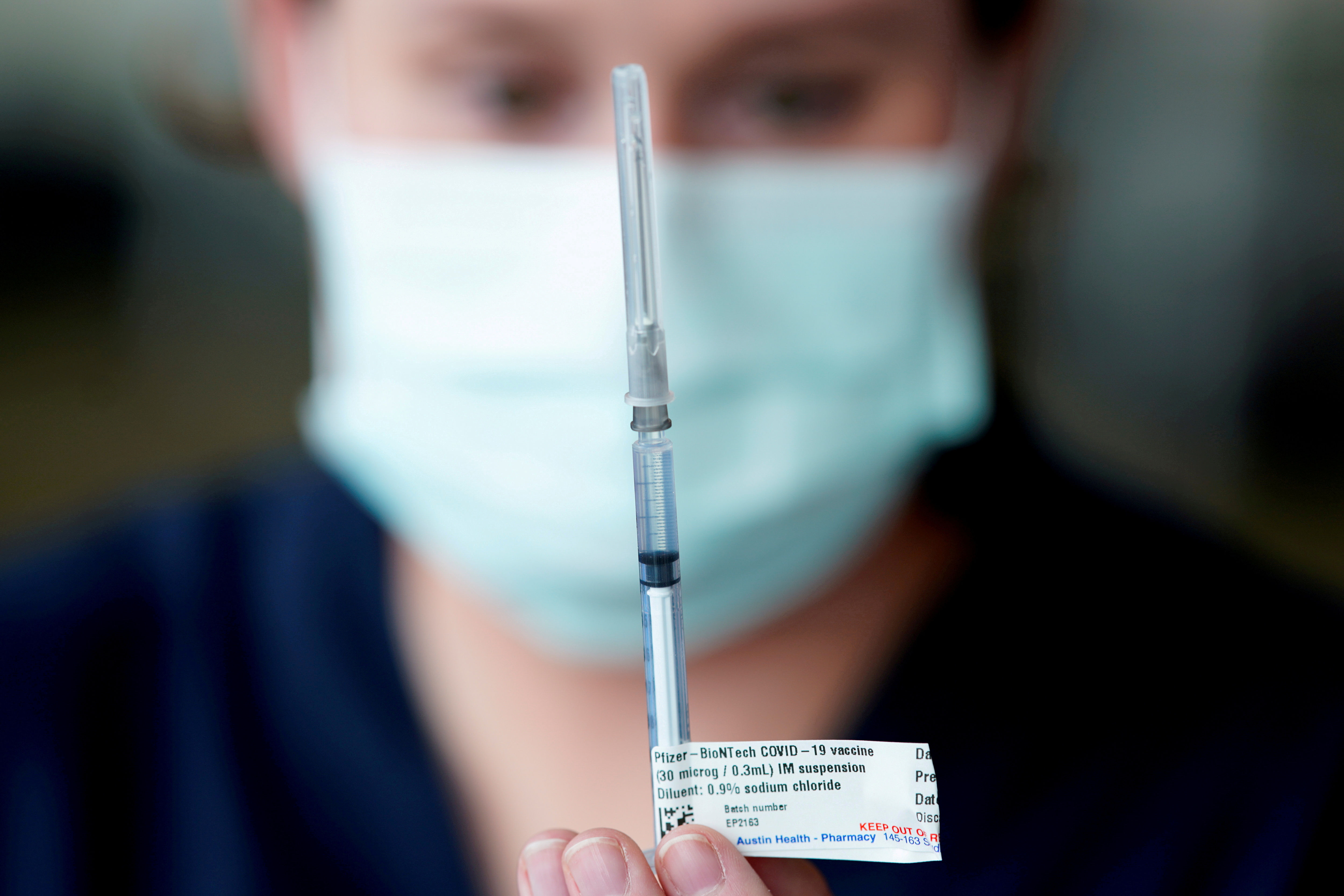 FILE PHOTO: The Pfizer COVID-19 vaccine is prepared by a healthcare worker in Melbourne