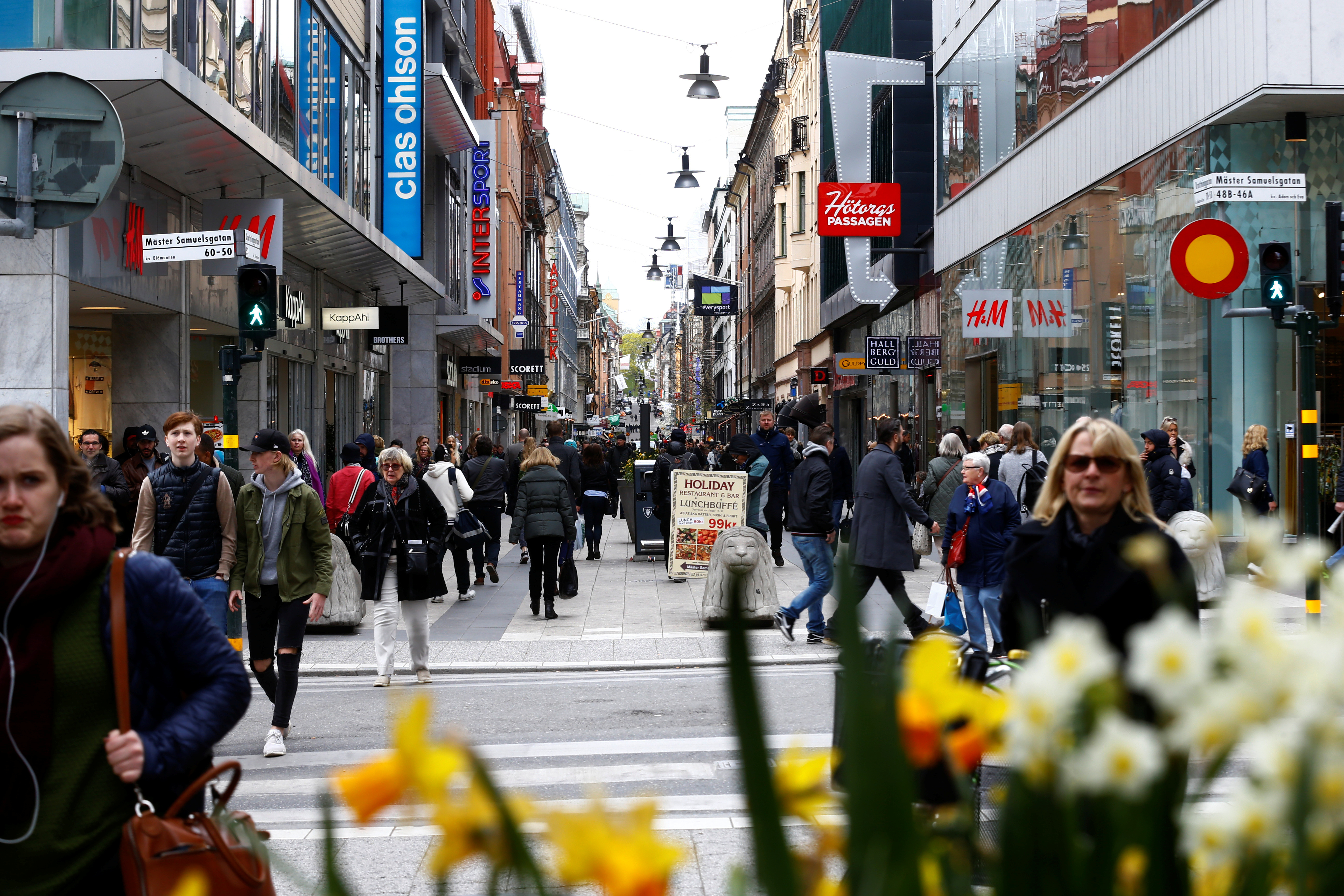People walk through the shopping area on the pedestrian street Drottninggatan in Stockholm