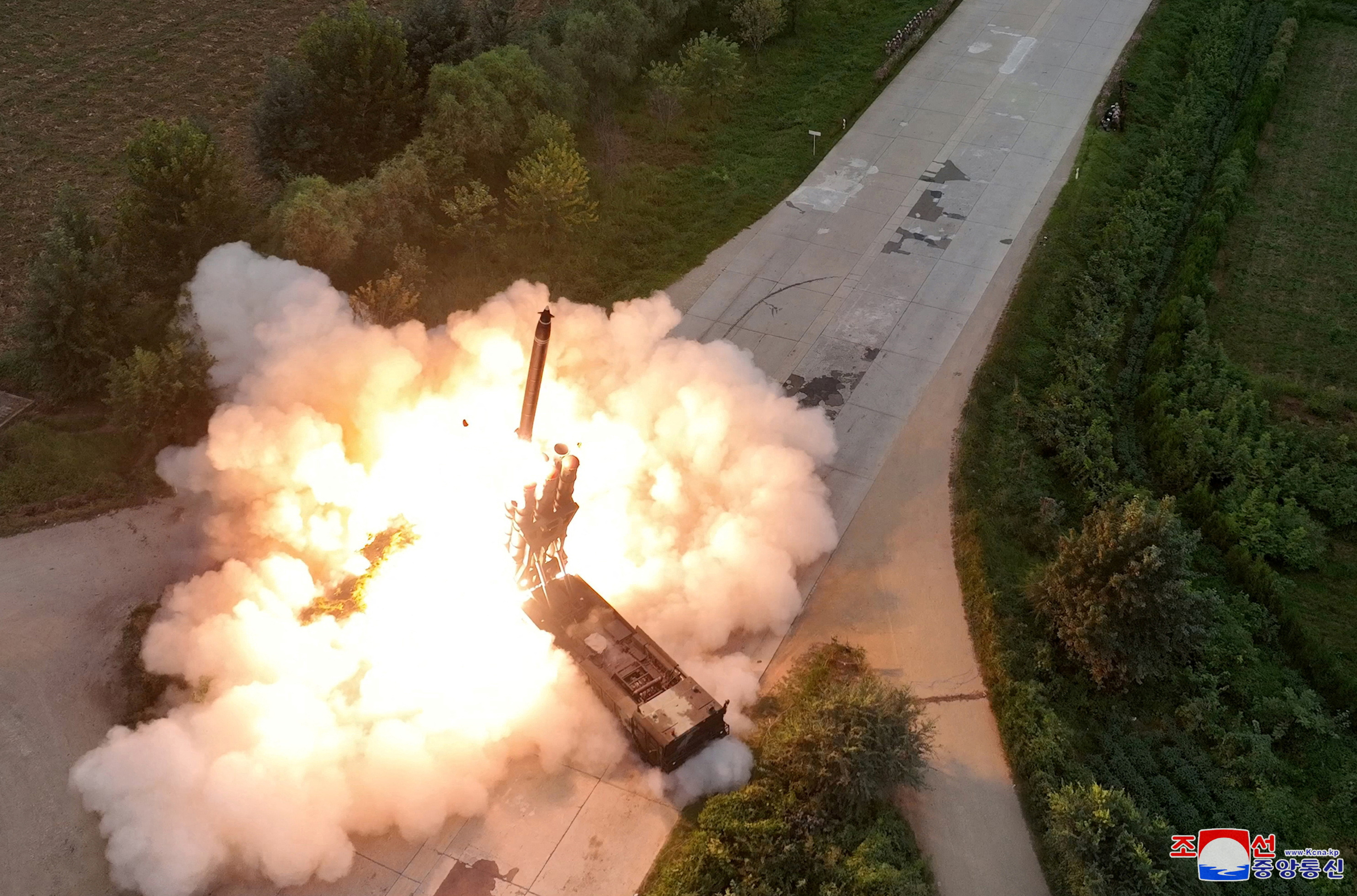 North Korean leader Kim Jong Un oversees a test-fire for a new 600mm multiple rocket launcher