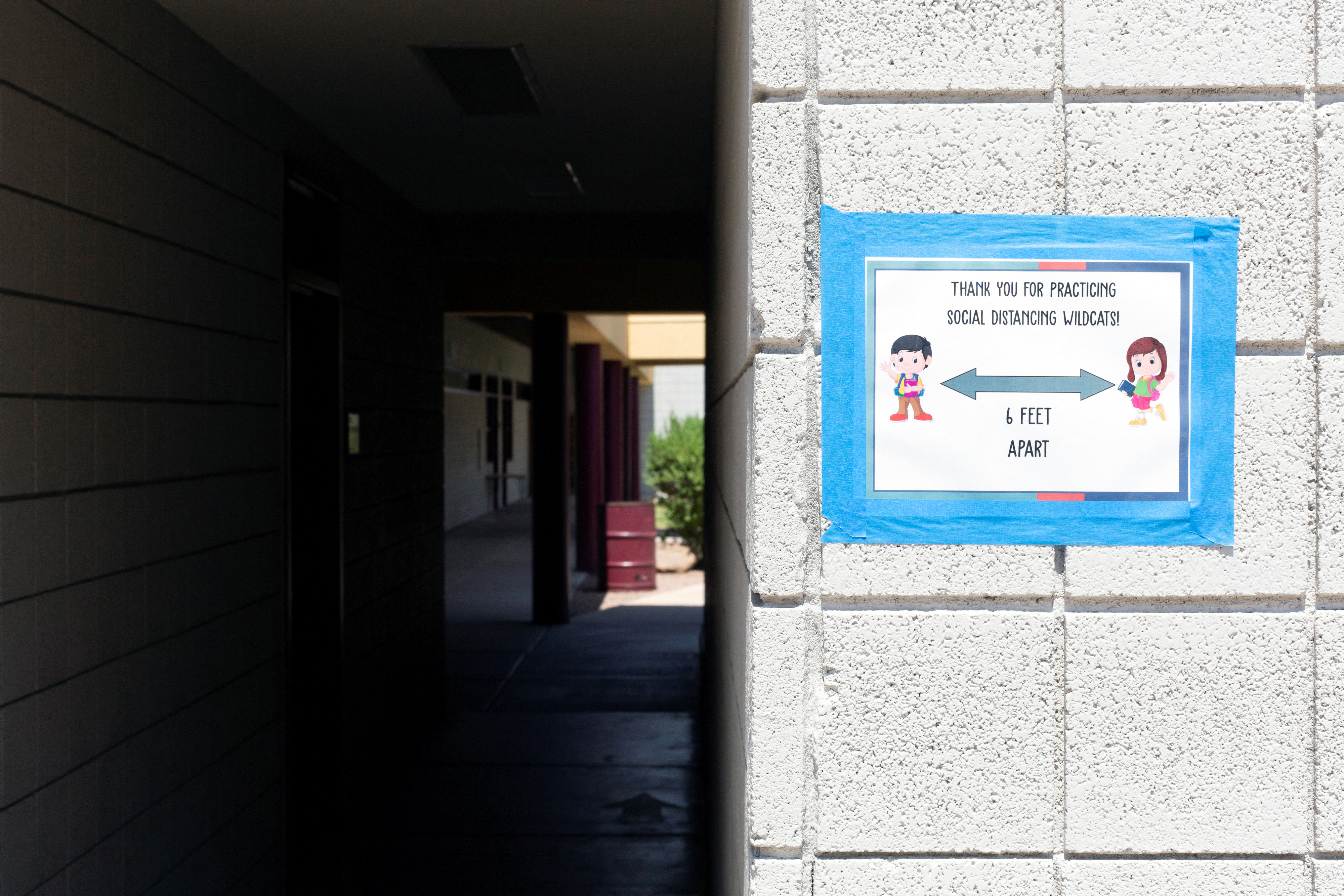 A sign indicates social distancing protocols as in-person learning resumes with restrictions in place to prevent the spread of coronavirus disease (COVID-19) at Wilson Primary School in Phoenix, Arizona, U.S., August 17, 2020.  REUTERS/Cheney Orr