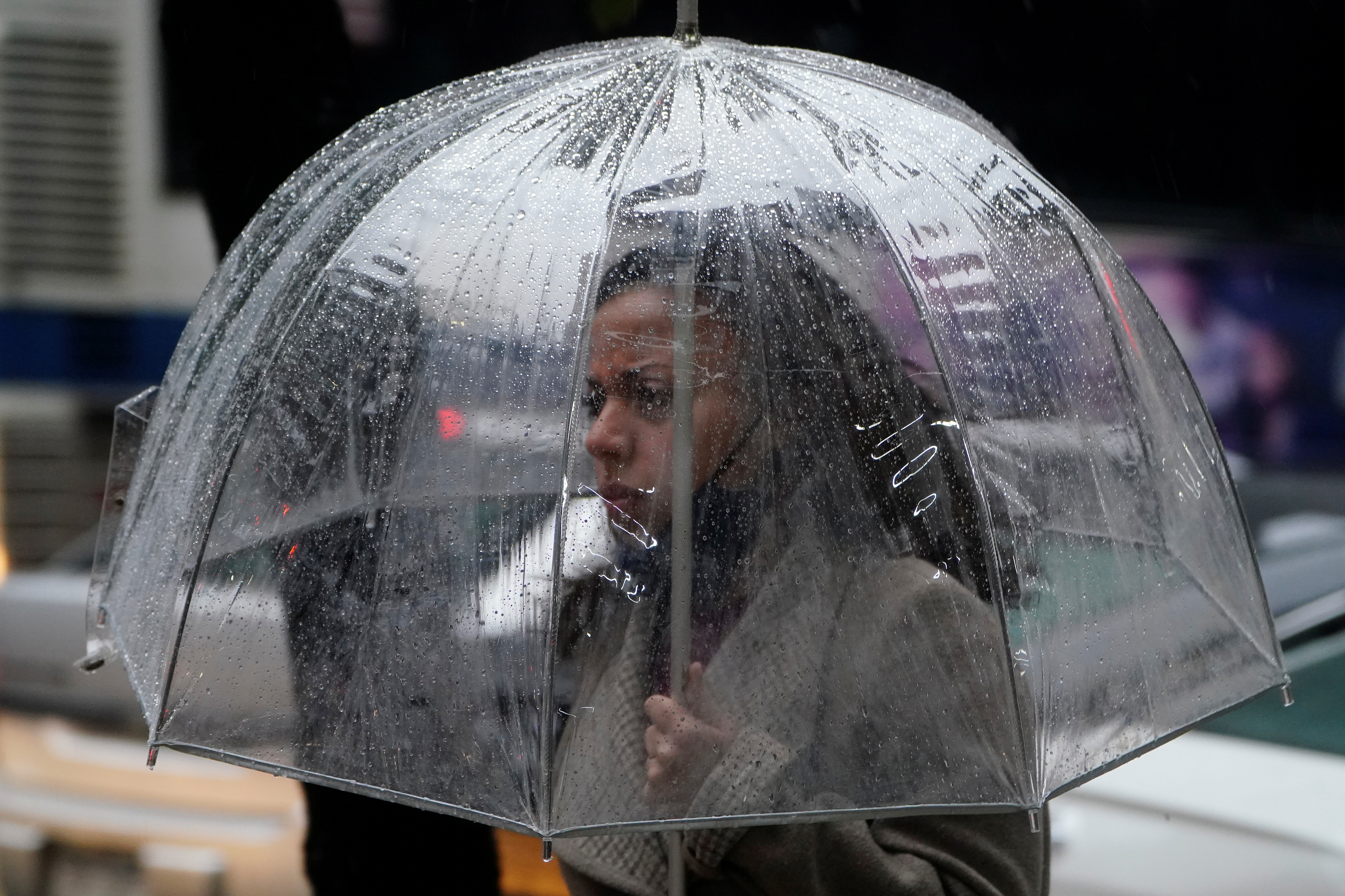 A woman with an umbrella walks in the rain in the Manhattan borough of New York City, New York, U.S. October 26, 2021.  REUTERS/Carlo Allegri