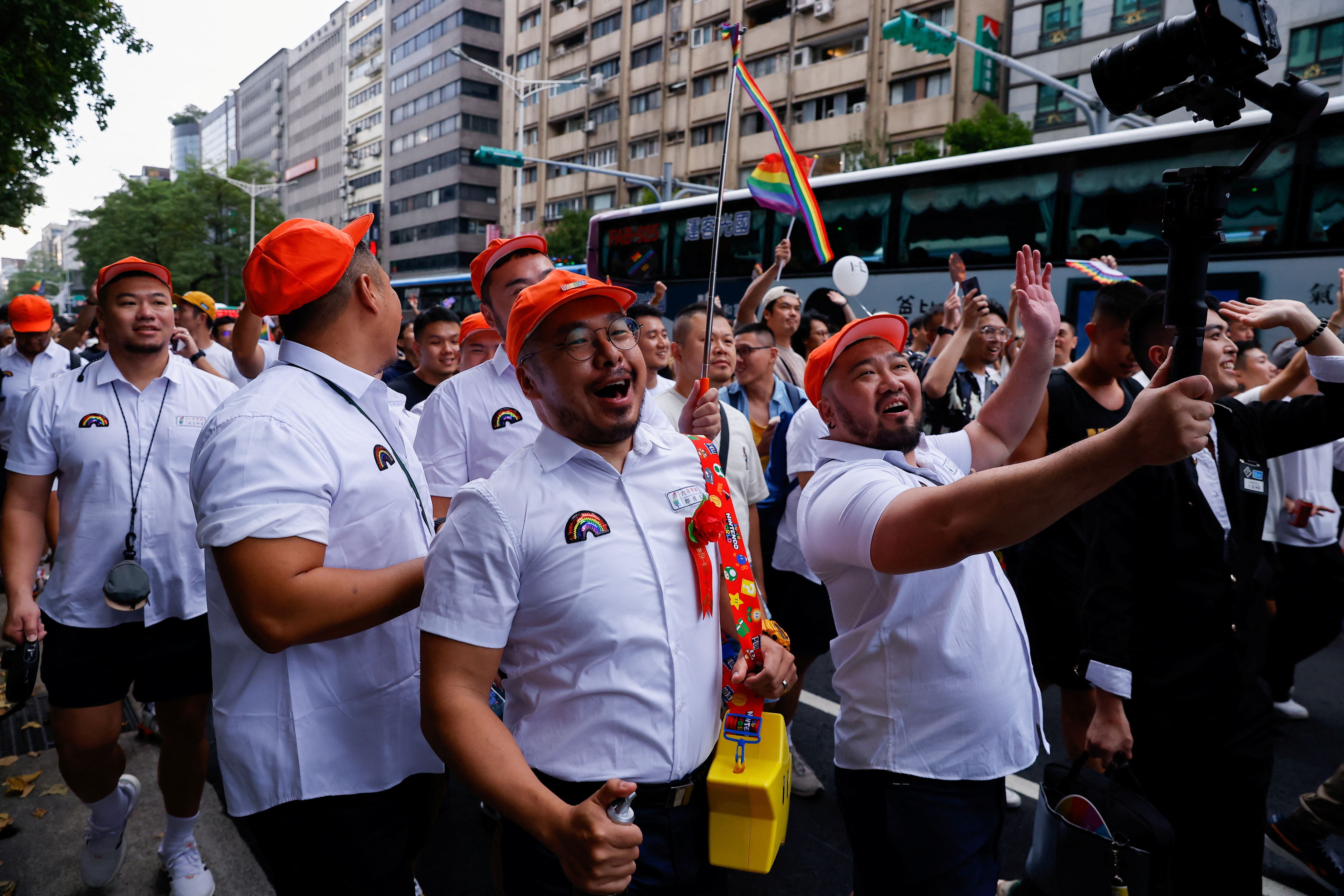 People take photos during the march at the annual Taiwan's Pride parade in Taipei,