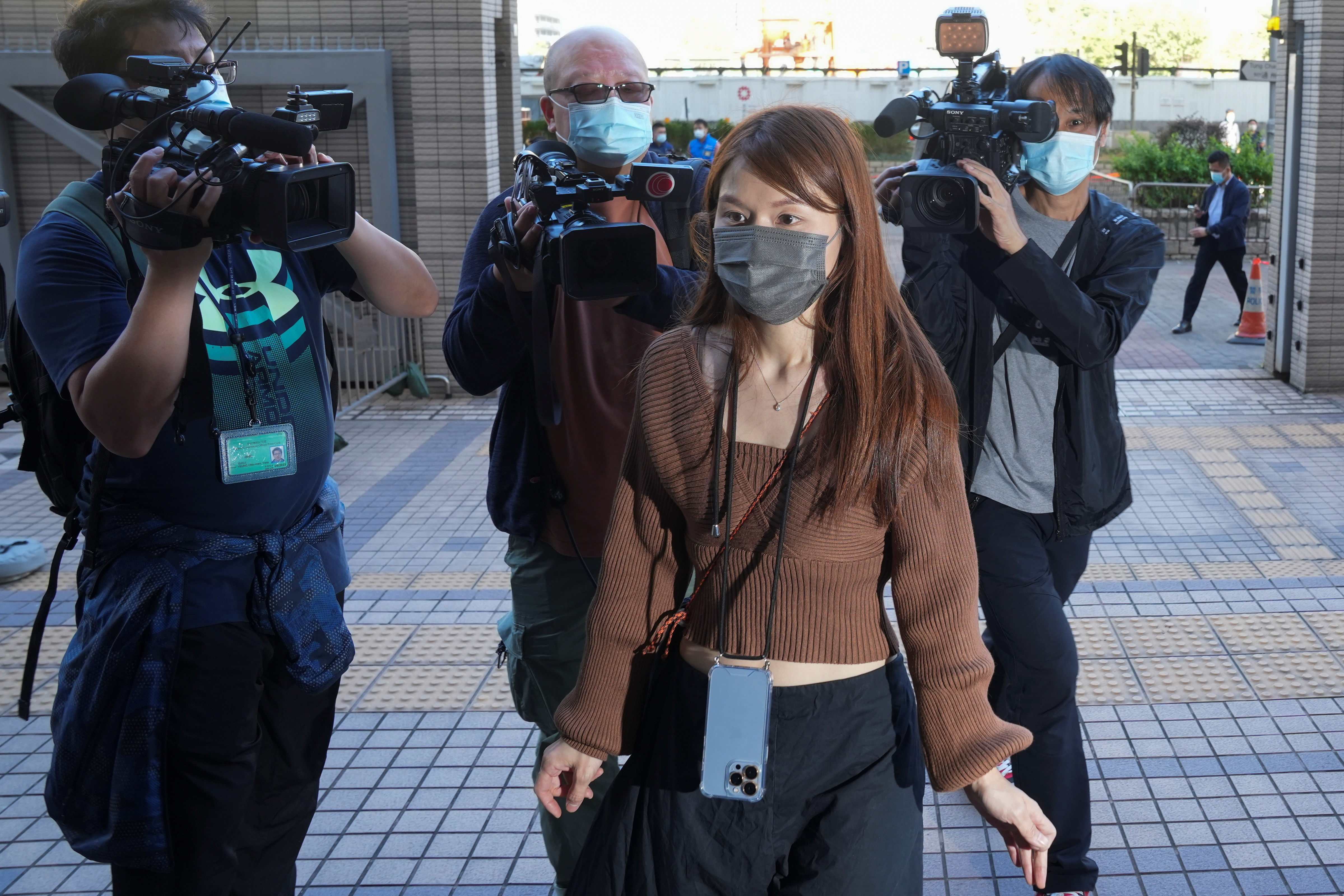 Clarisse Yeung Suet-Ying, one of the 47 pro-democracy activists charged with conspiracy to commit subversion under the national security law, arrives at West Kowloon Magistrates' Courts building, in Hong Kong, China November 29, 2021. REUTERS/Lam Yik