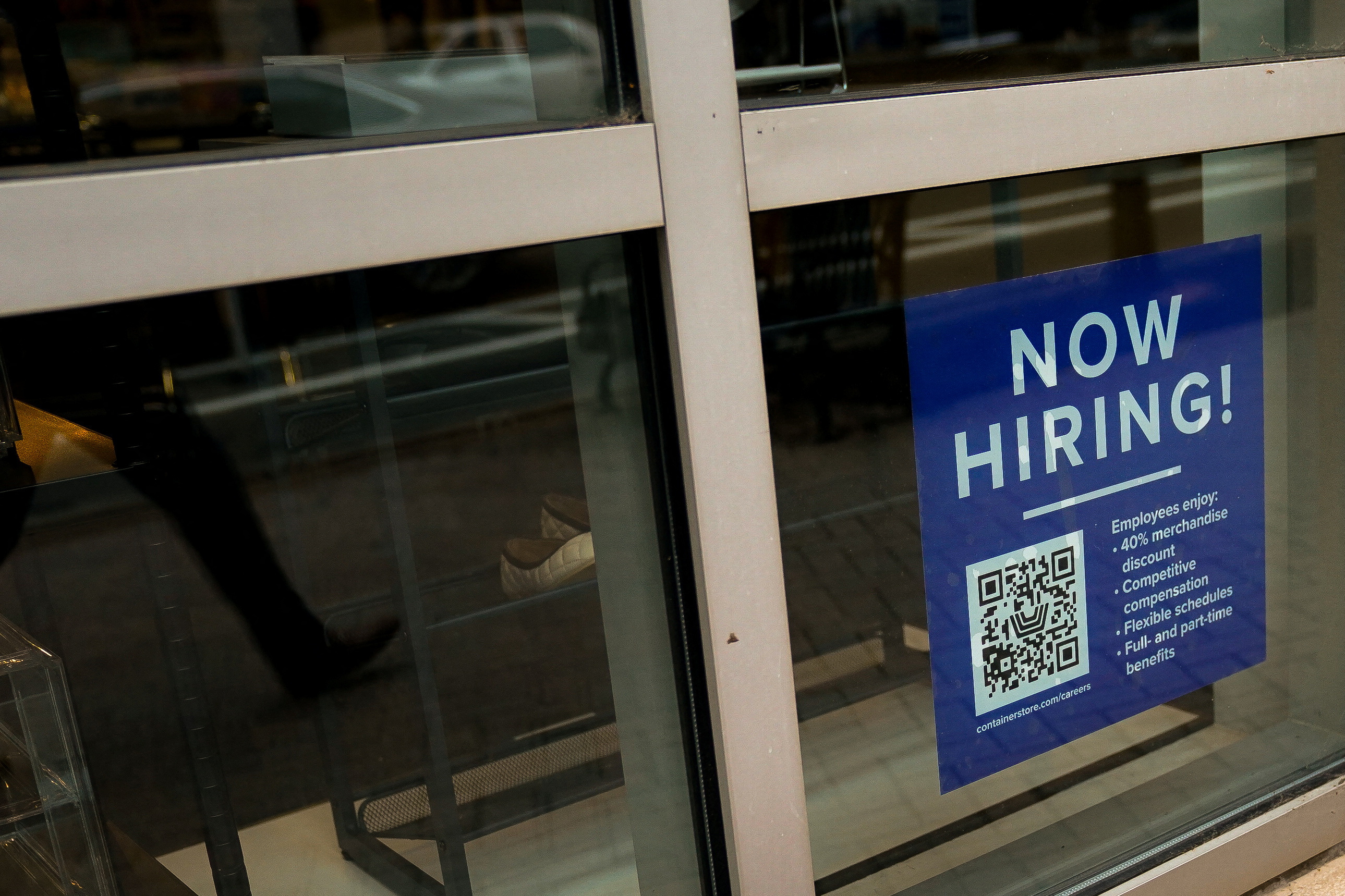 Aparece un cartel de empleo de empleado con un código QR en una ventana comercial de Arlington