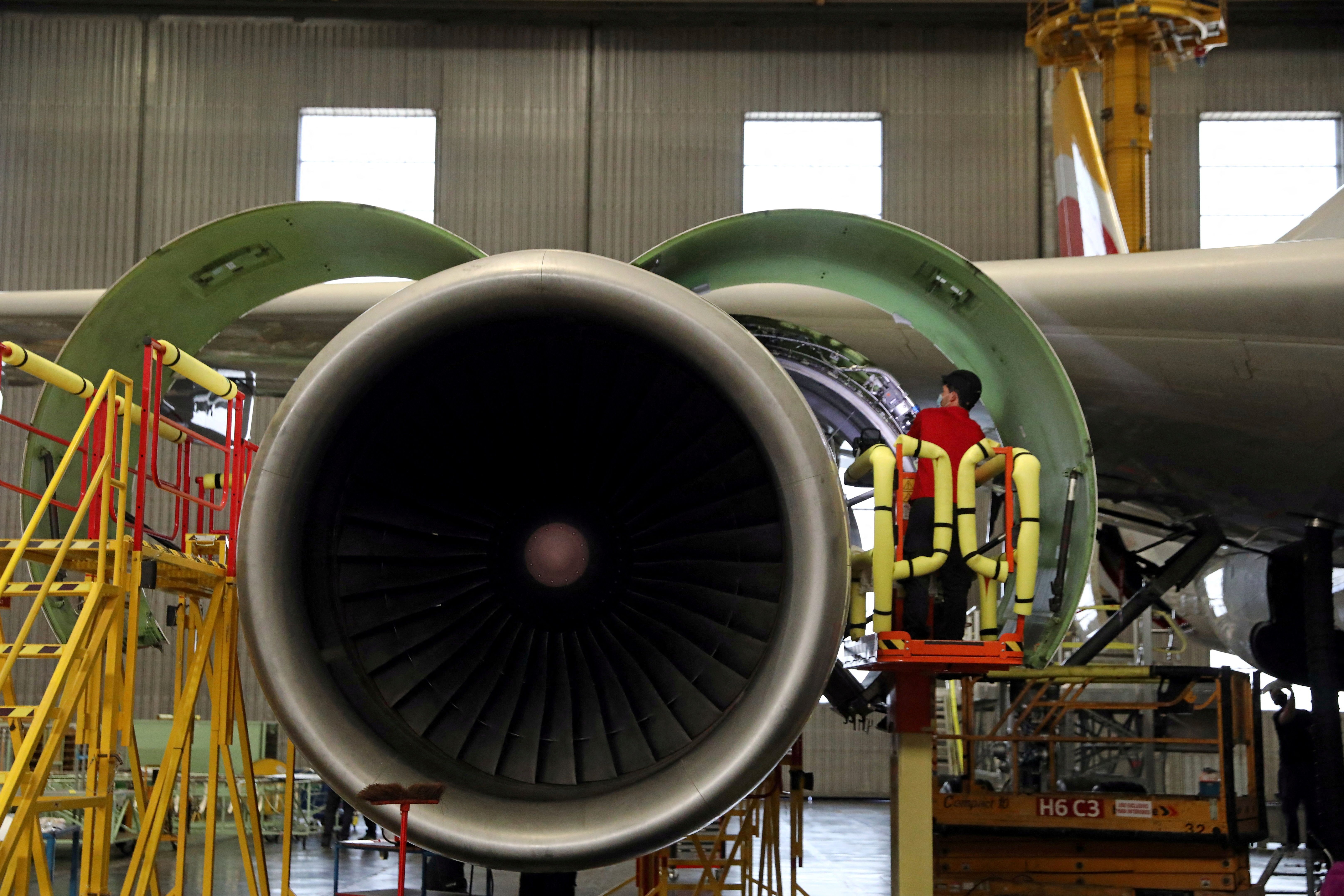 An IAG Iberia's worker inspects an engine after transforming an Airbus 330 passenger aircraft into a cargo one in Madrid