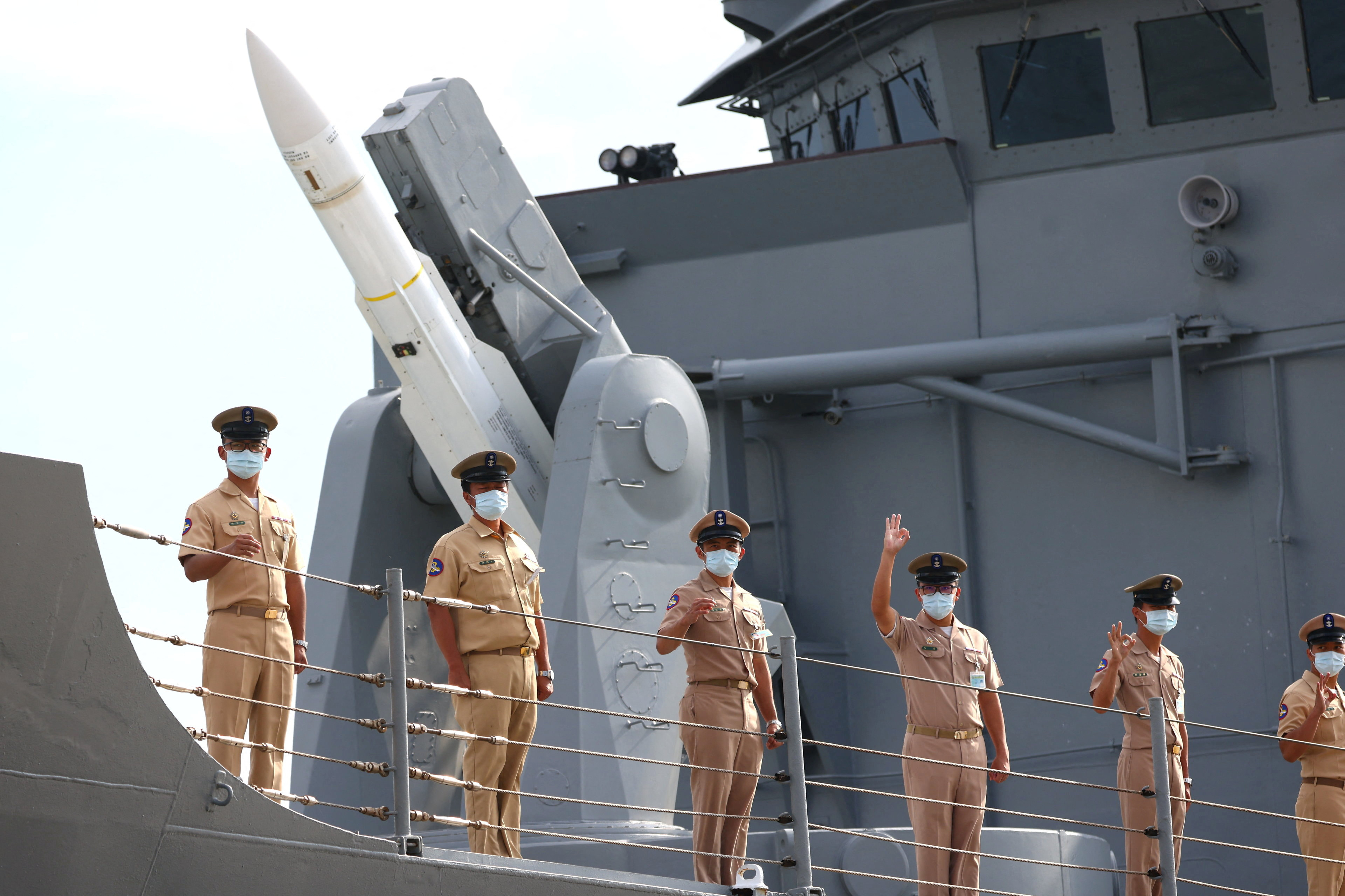 Members of the navy stand in front of a U.S.-made missile on a frigate at a navy base in Penghu Islands