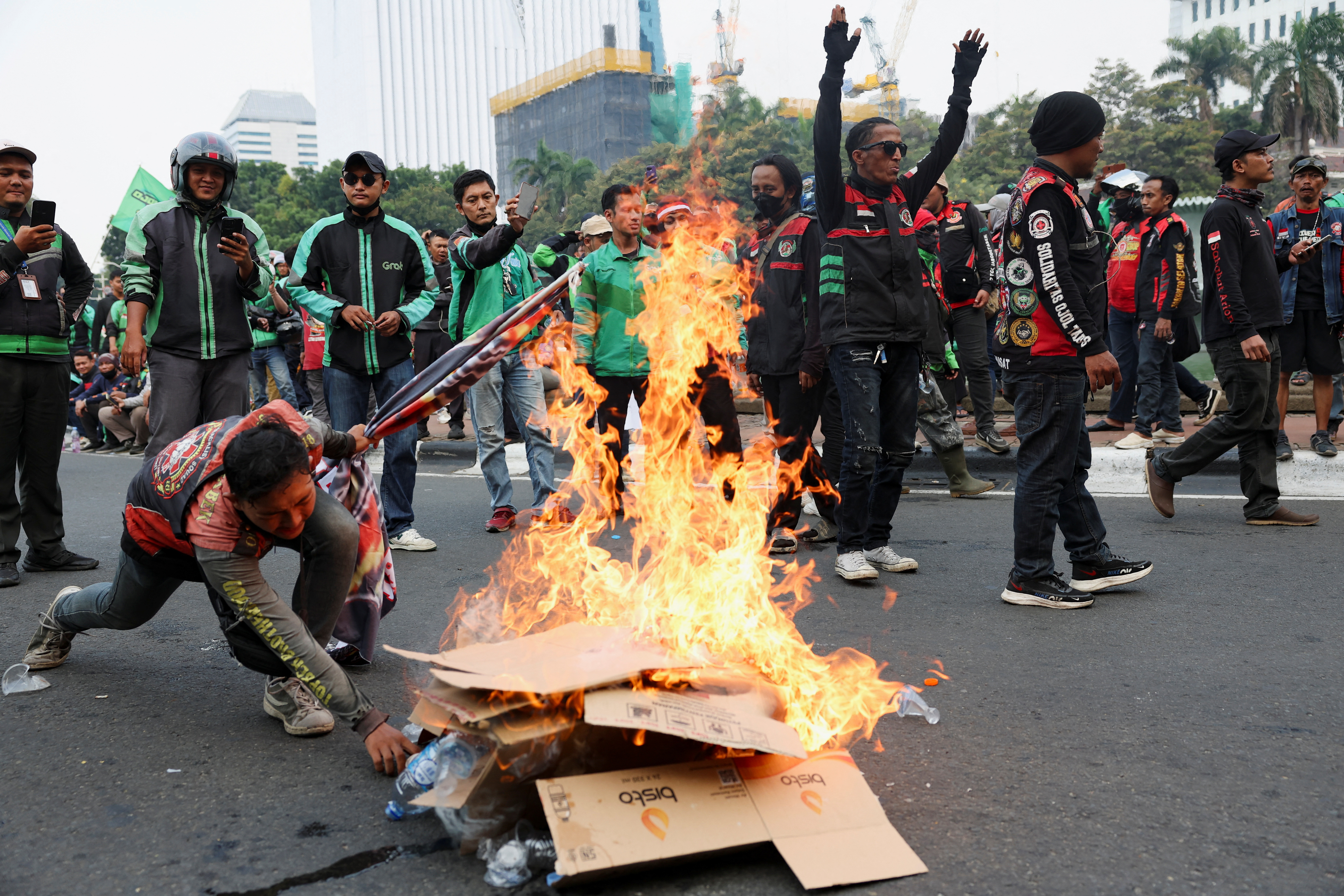 Motorcycle taxi drivers working for online ride-hailing start-ups protest against low tariffs in Jakarta