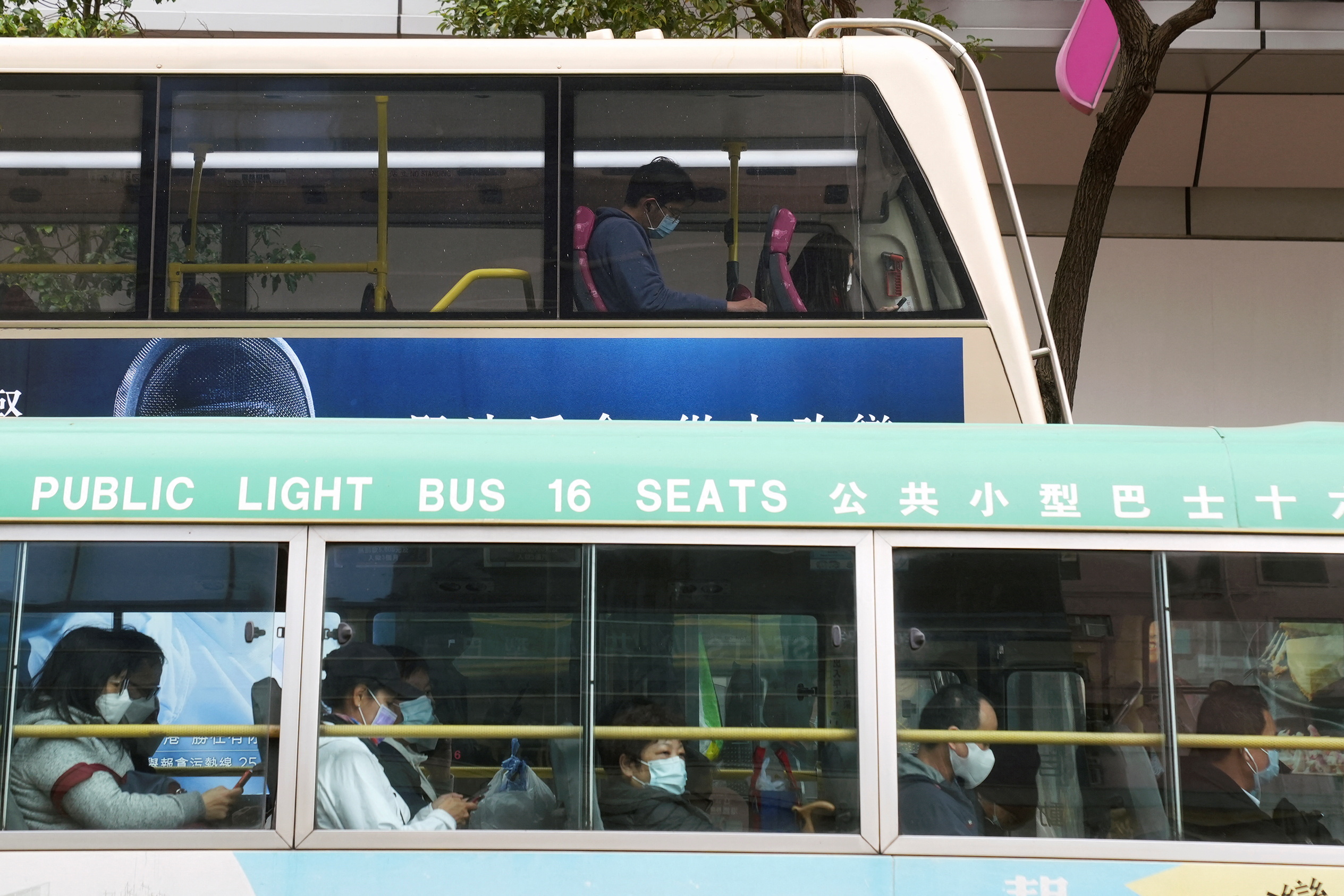 Commuters wearing face masks following the coronavirus disease (COVID-19) outbreak, ride public buses in Hong Kong
