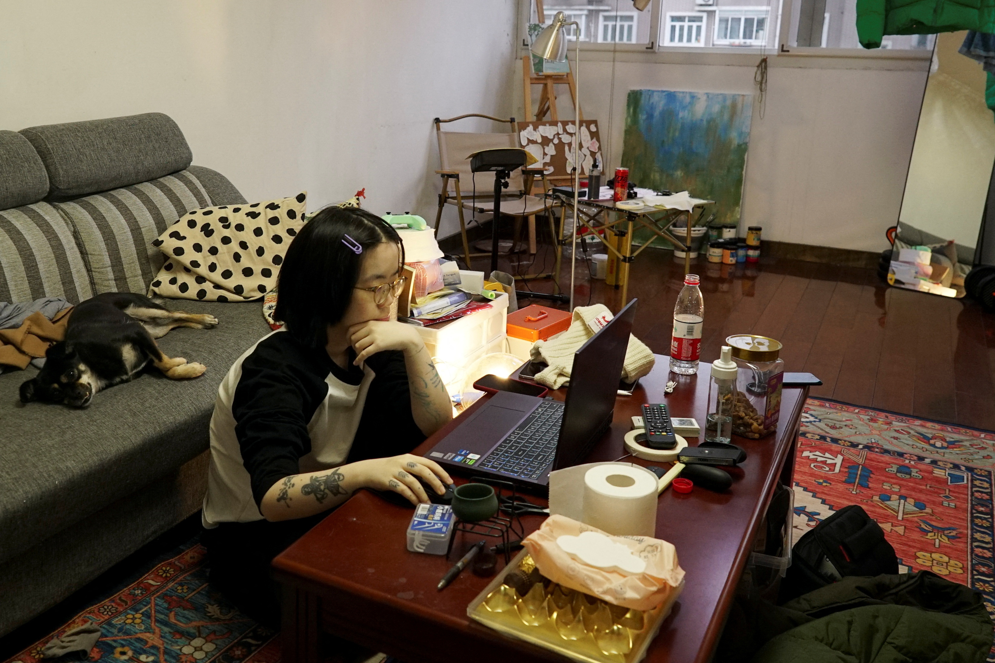 Tattoo apprentice Chu Yi uses a laptop in Shanghai